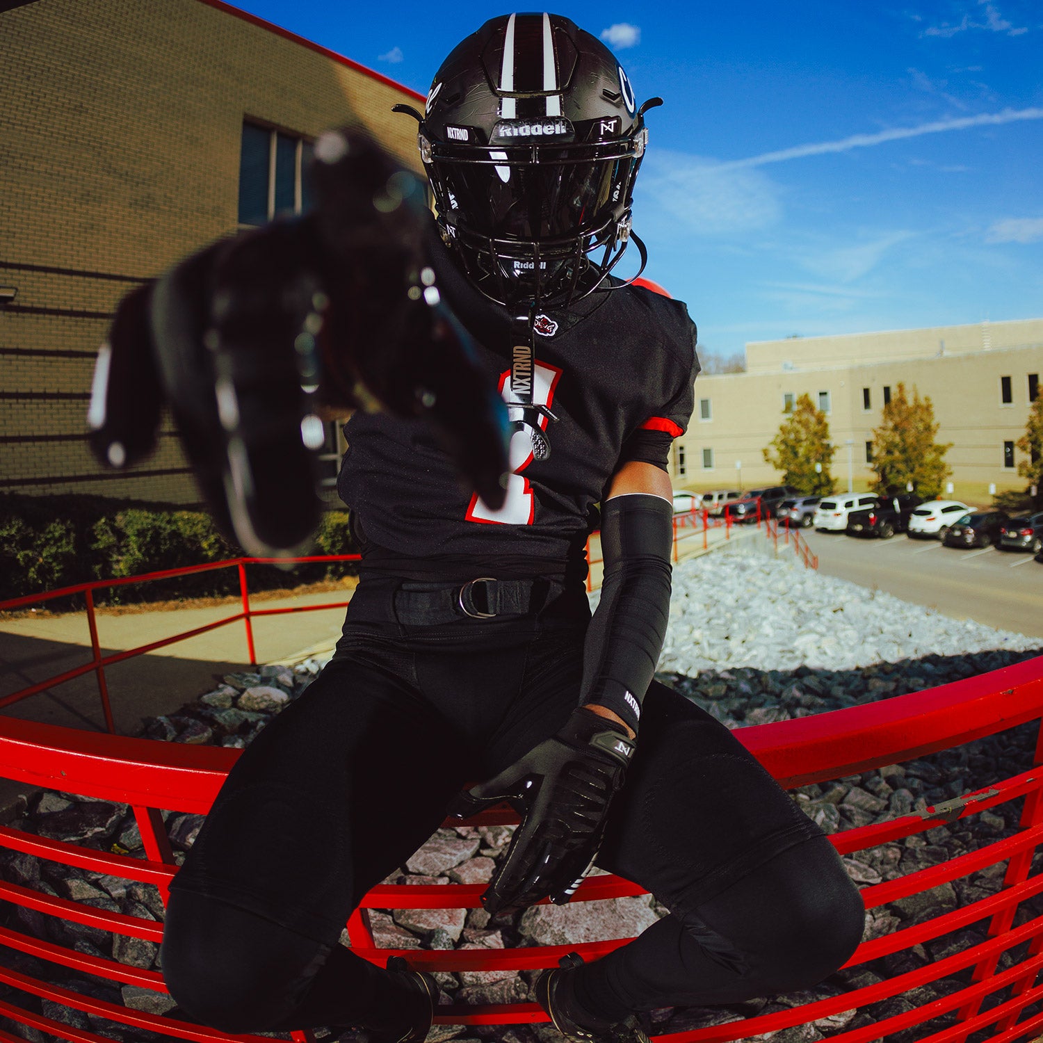 High School Football Player Wearing NXTRND G1 Pro Football Gloves Black and Compression Sleeve Black