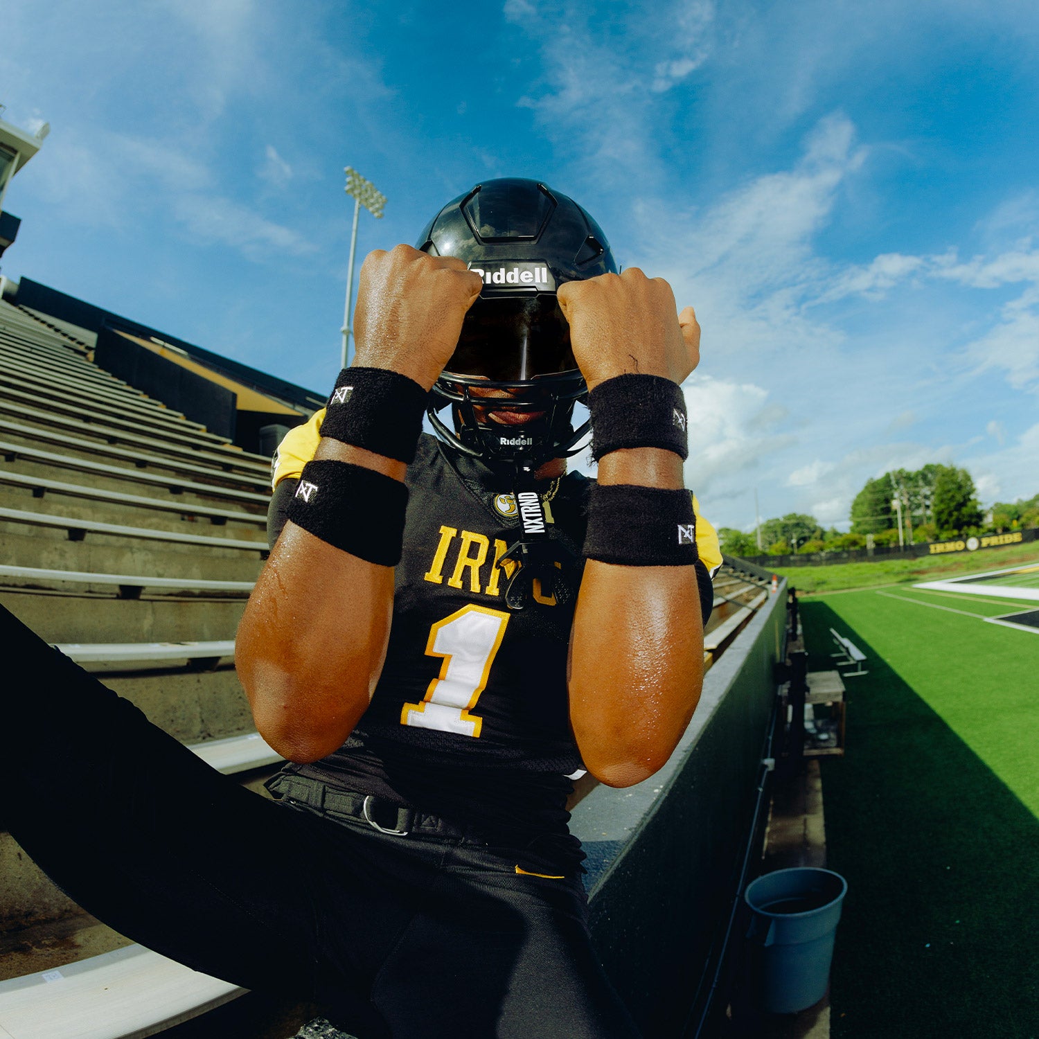 High School Football Player Wearing NXTRND Wrist Band Black and TWO Football Mouthguard
