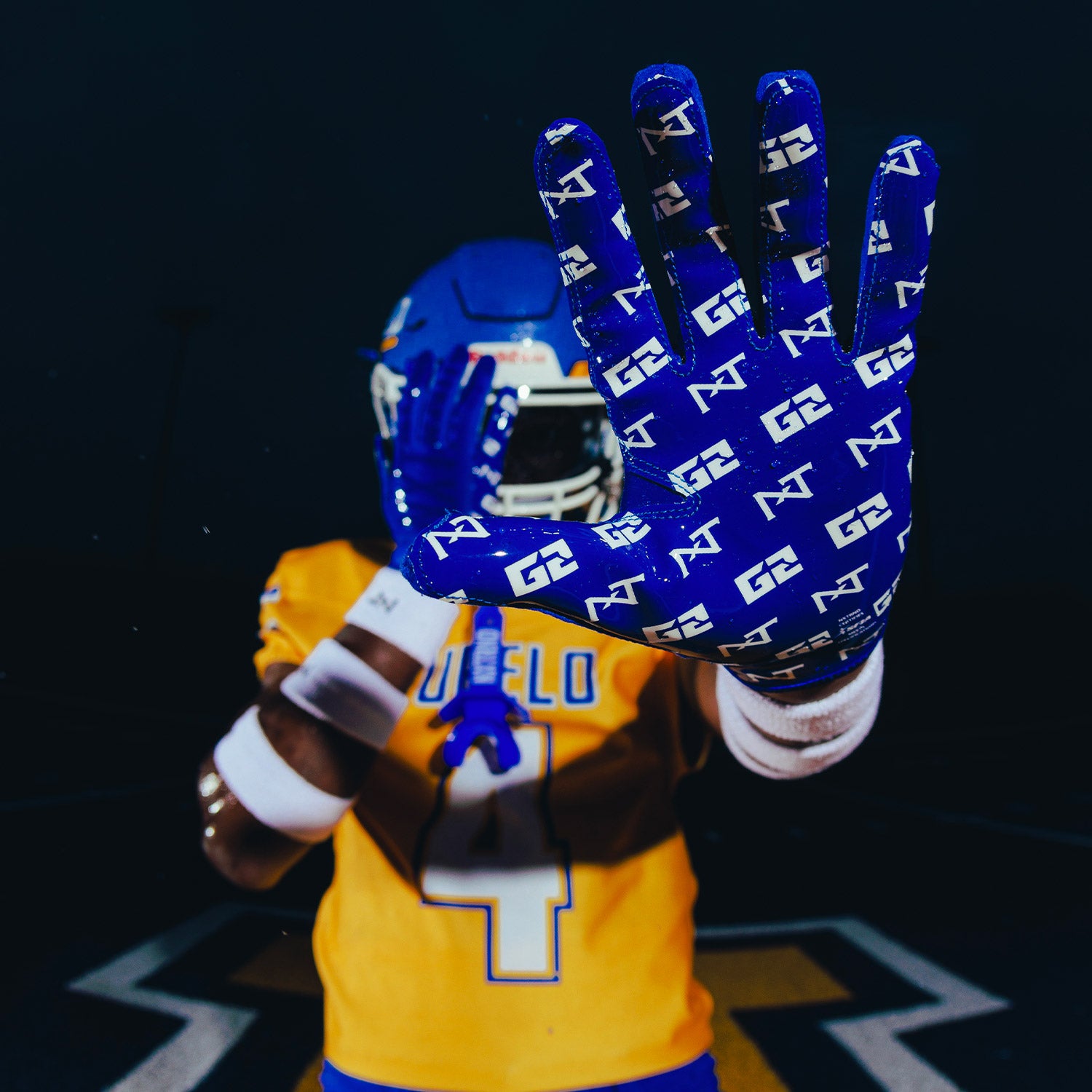 High School Football Player Wearing NXTRND G2 Pro Football Gloves Blue and Wrist Band White Close Up