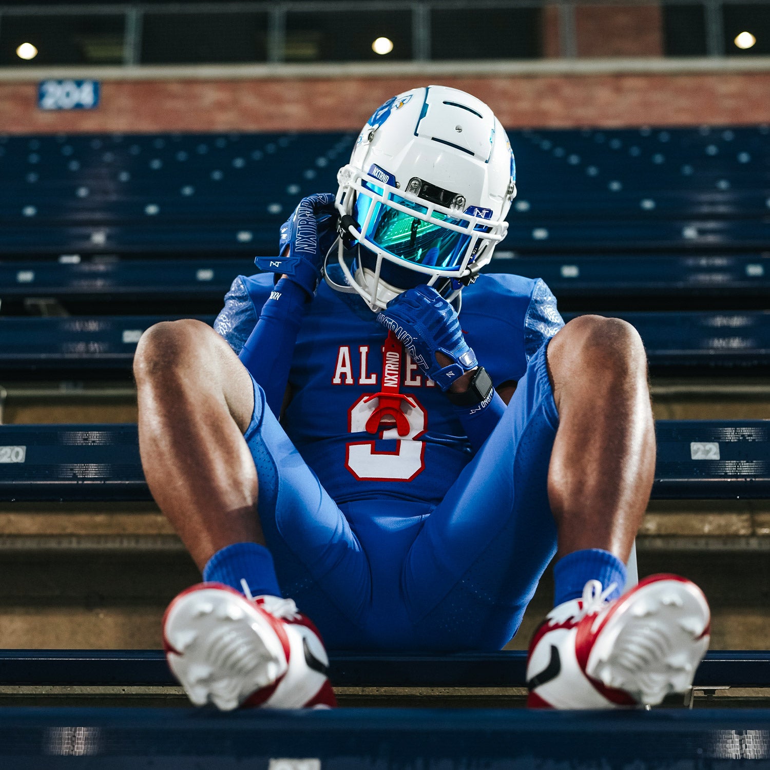 High School Football Player Wearing NXTRND Crew Mid Cut Padded Socks Blue and VZR3 Football Visor Blue