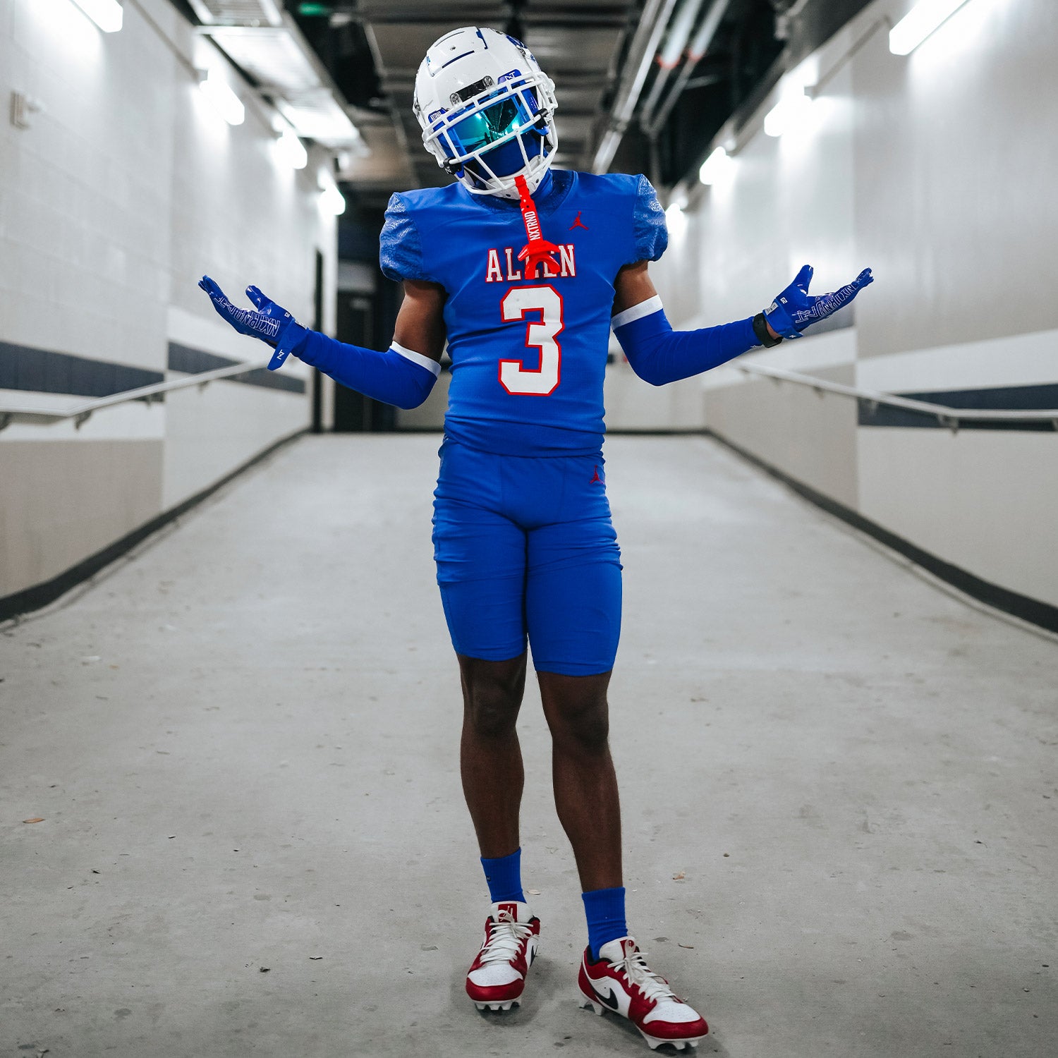 High School Football Player Wearing NXTRND Crew Mid Cut Padded Socks Blue and Double Compression Arm Sleeves Blue