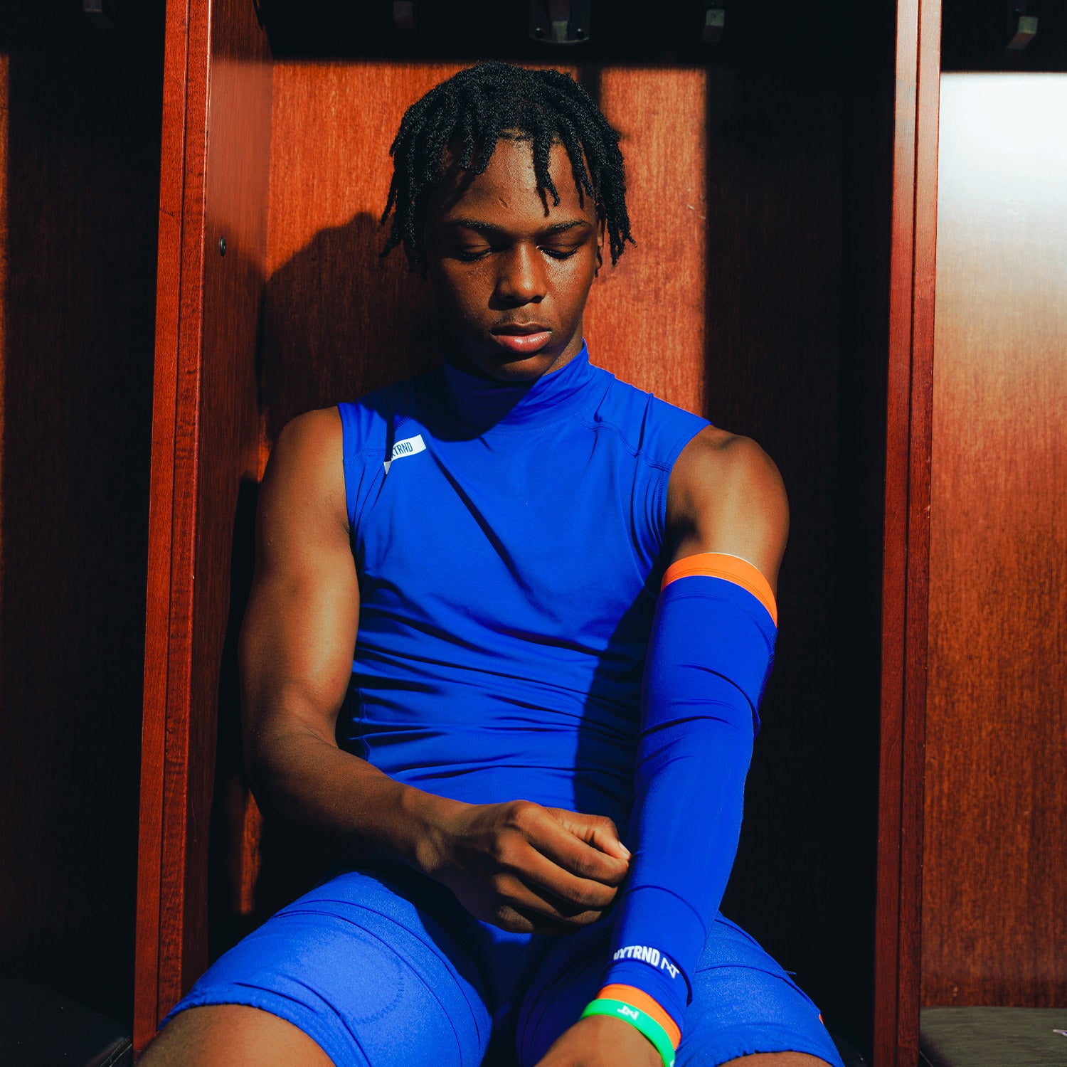 High School Football Player Wearing Core Sleeveless Compression Mock Neck Blue