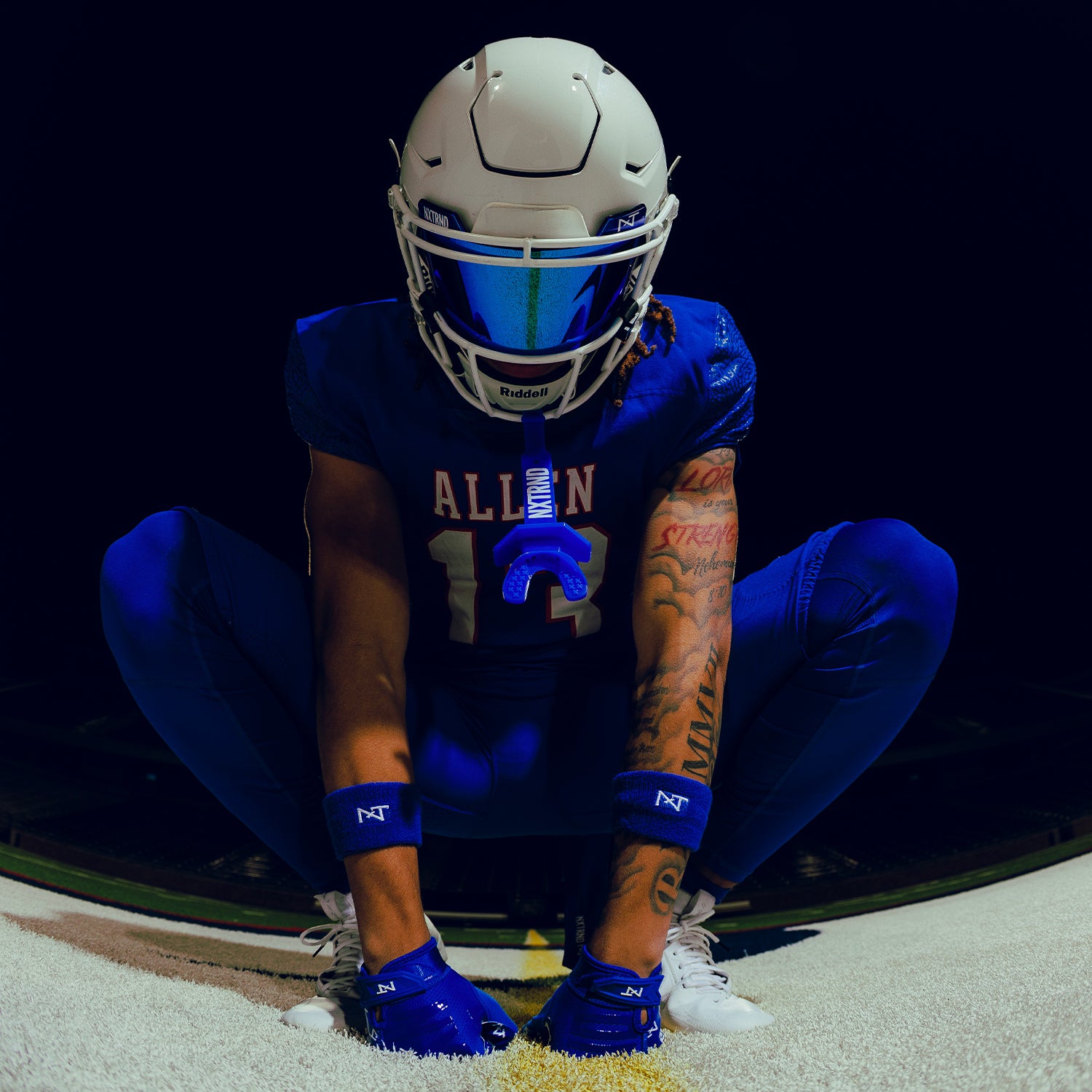High School Football Player Wearing NXTRND Wrist Band Blue and VZR3 Football Visor Blue