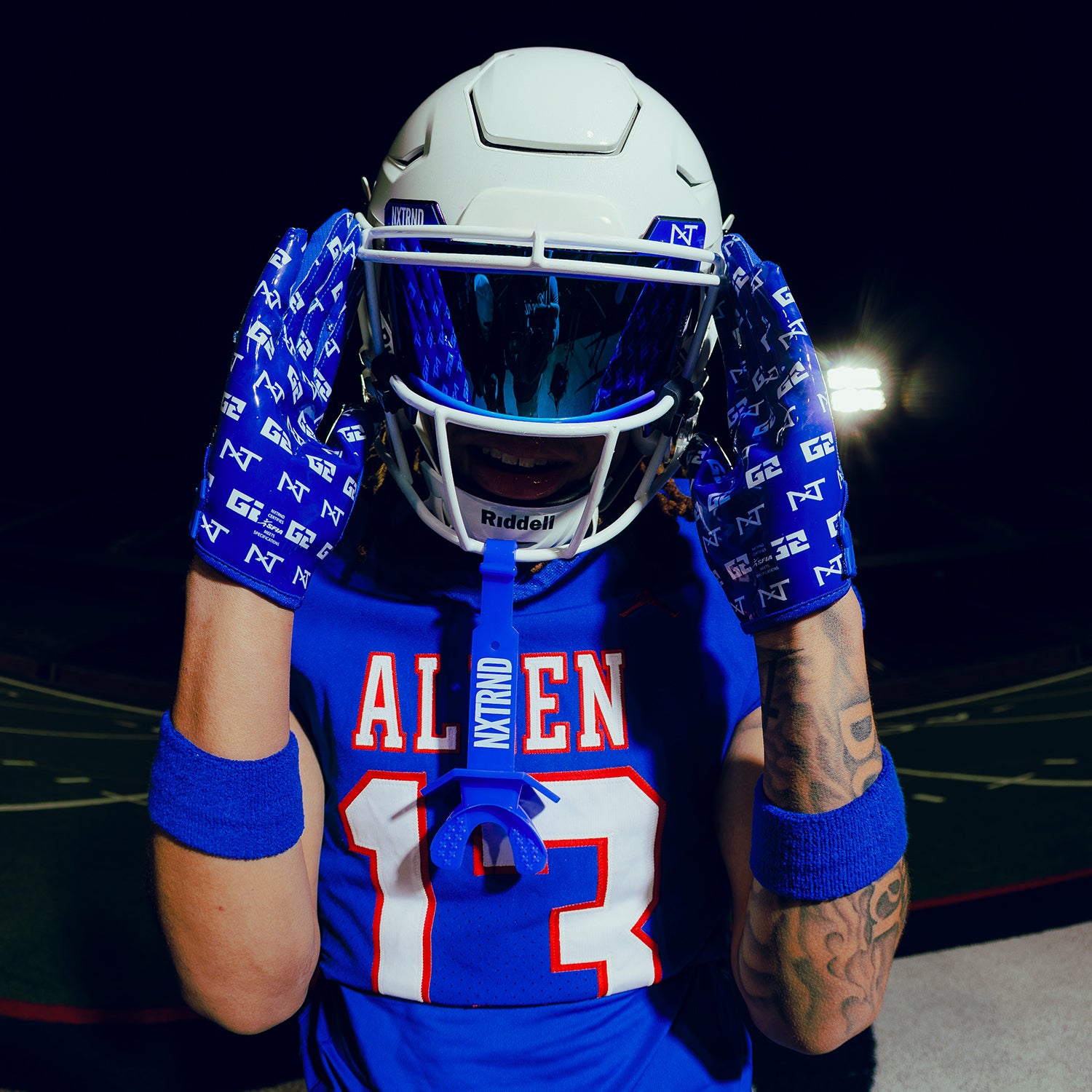 High School Football Player Wearing NXTRND Wrist Band Blue and G2 Pro Football Gloves Blue