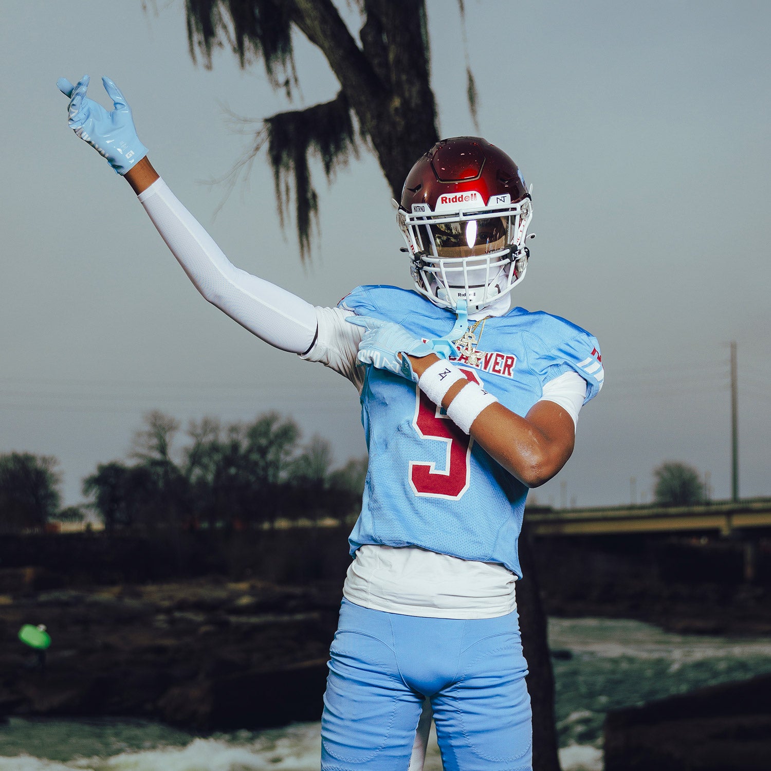 High School Football Player Wearing NXTRND G1 Pro Football Gloves Columbia Blue and Compression Sleeve White