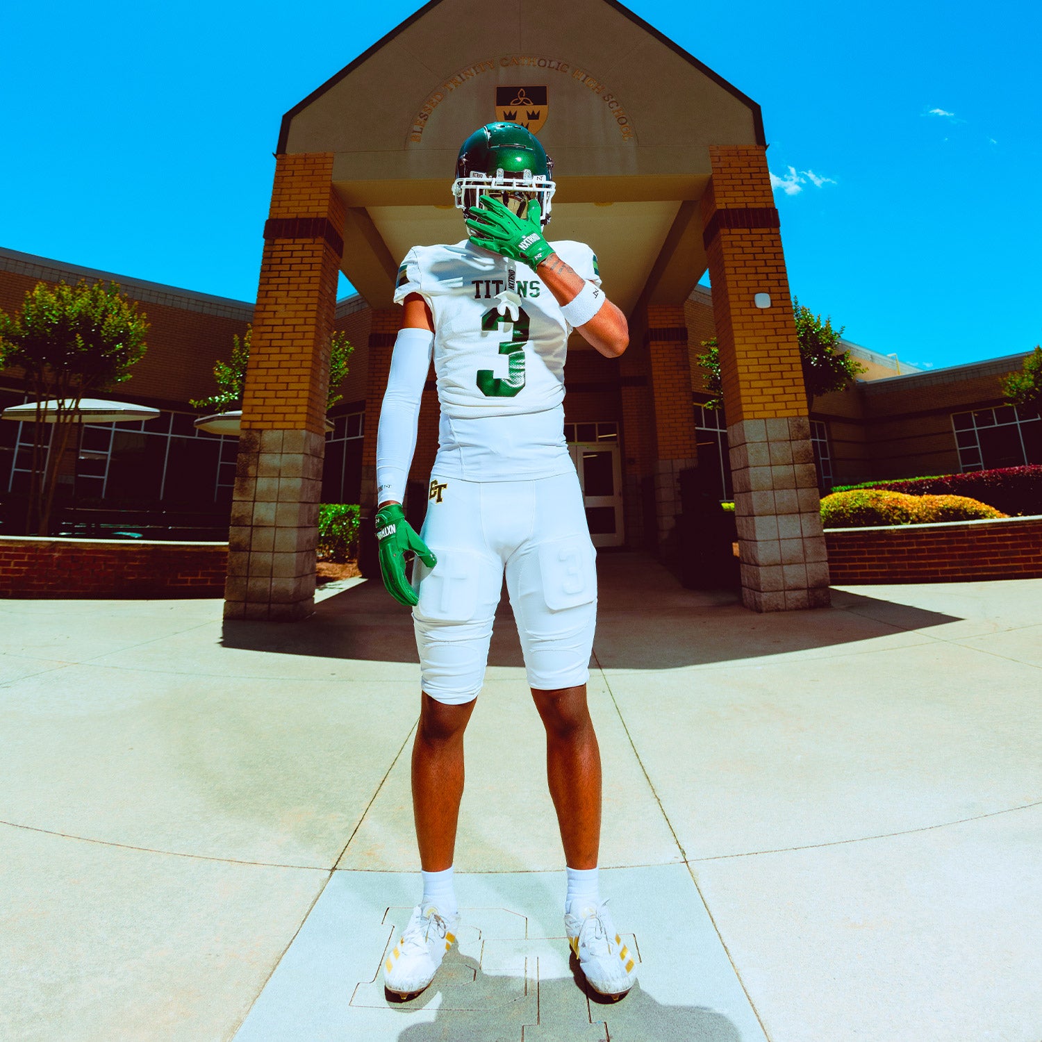 High School Football Player Outside Wearing NXTRND G3 Pro Padded Football Gloves Dark Green