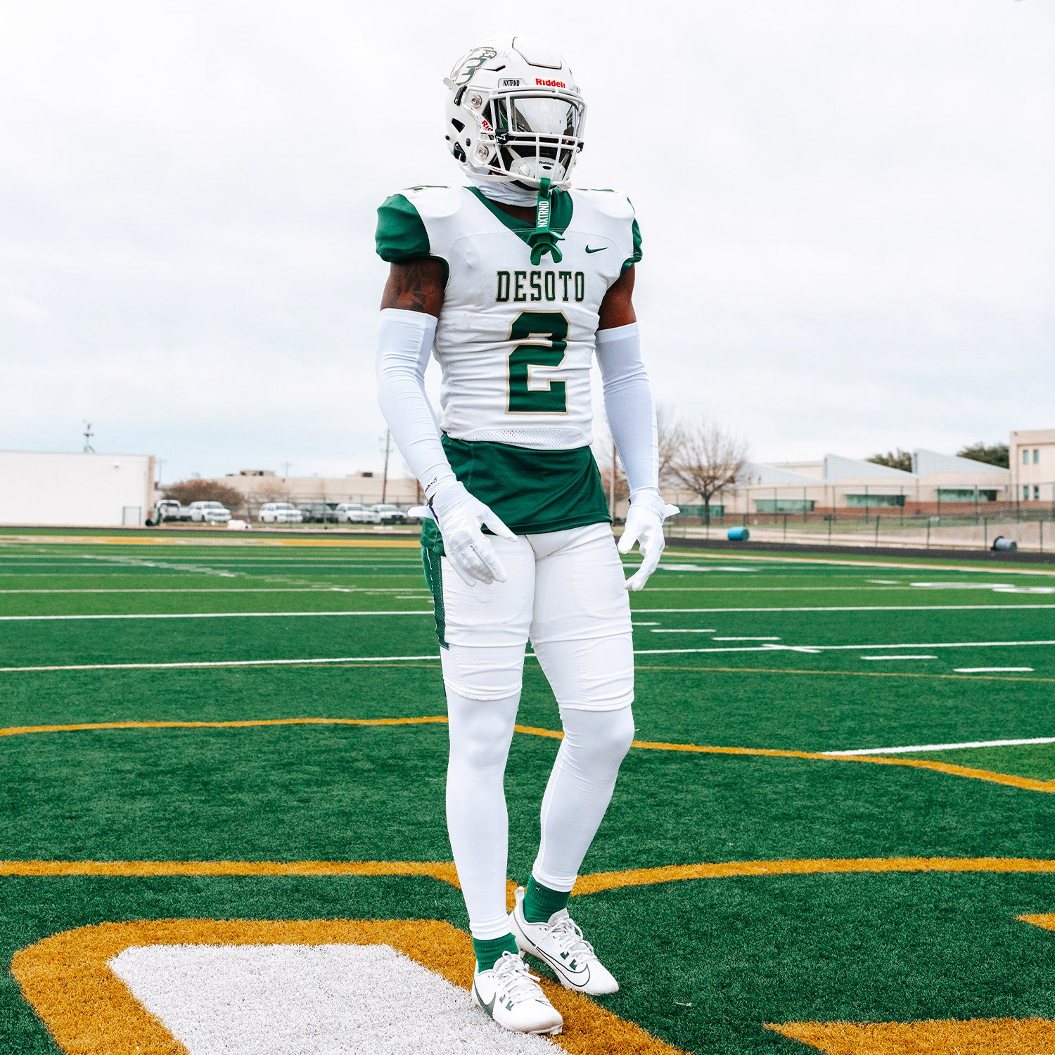 High School Football Player Wearing NXTRND Crew Mid Cut Padded Socks Dark Green and G1 Pro Football Gloves