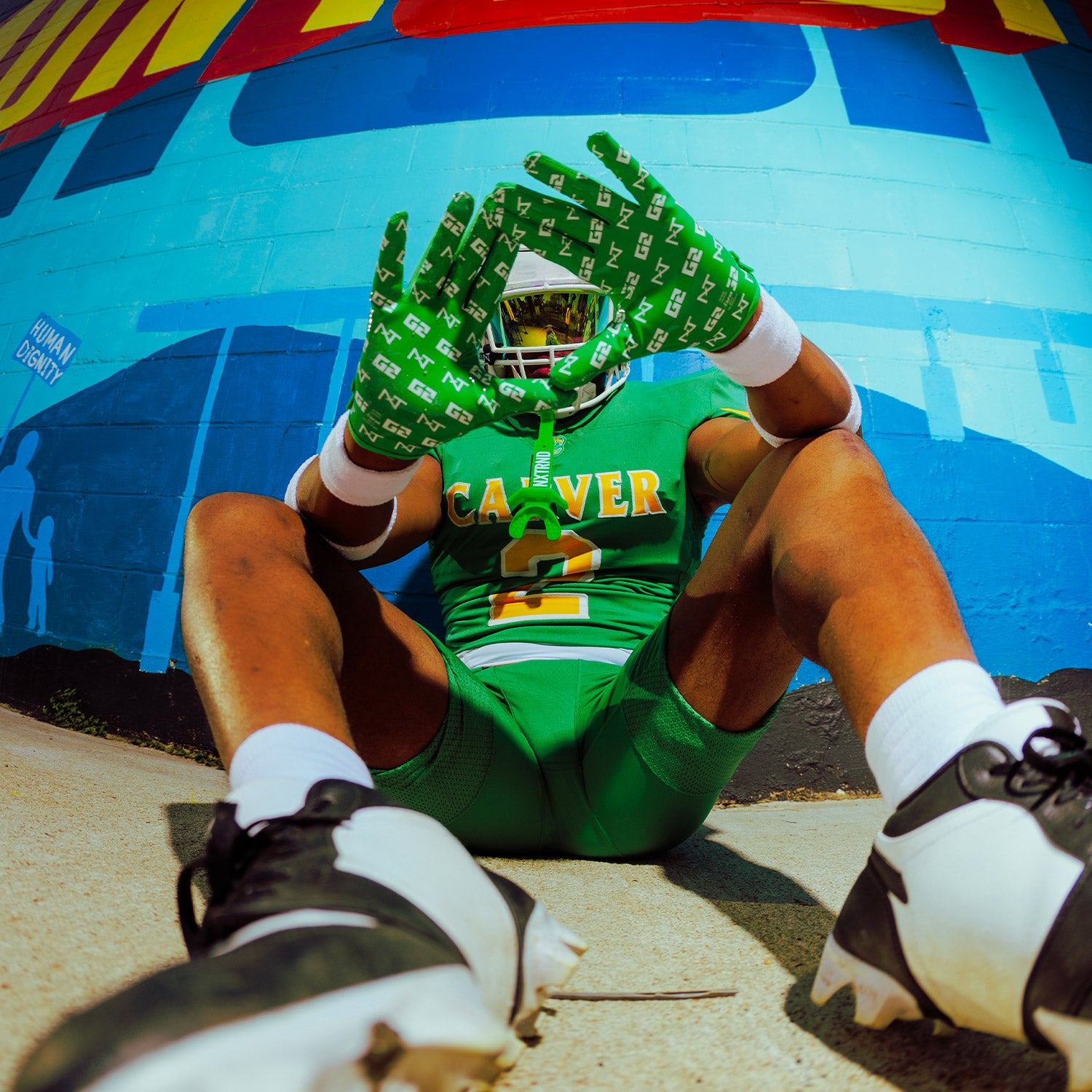 High School Football Player Wearing NXTRND G2 Pro Football Gloves Green Close Up