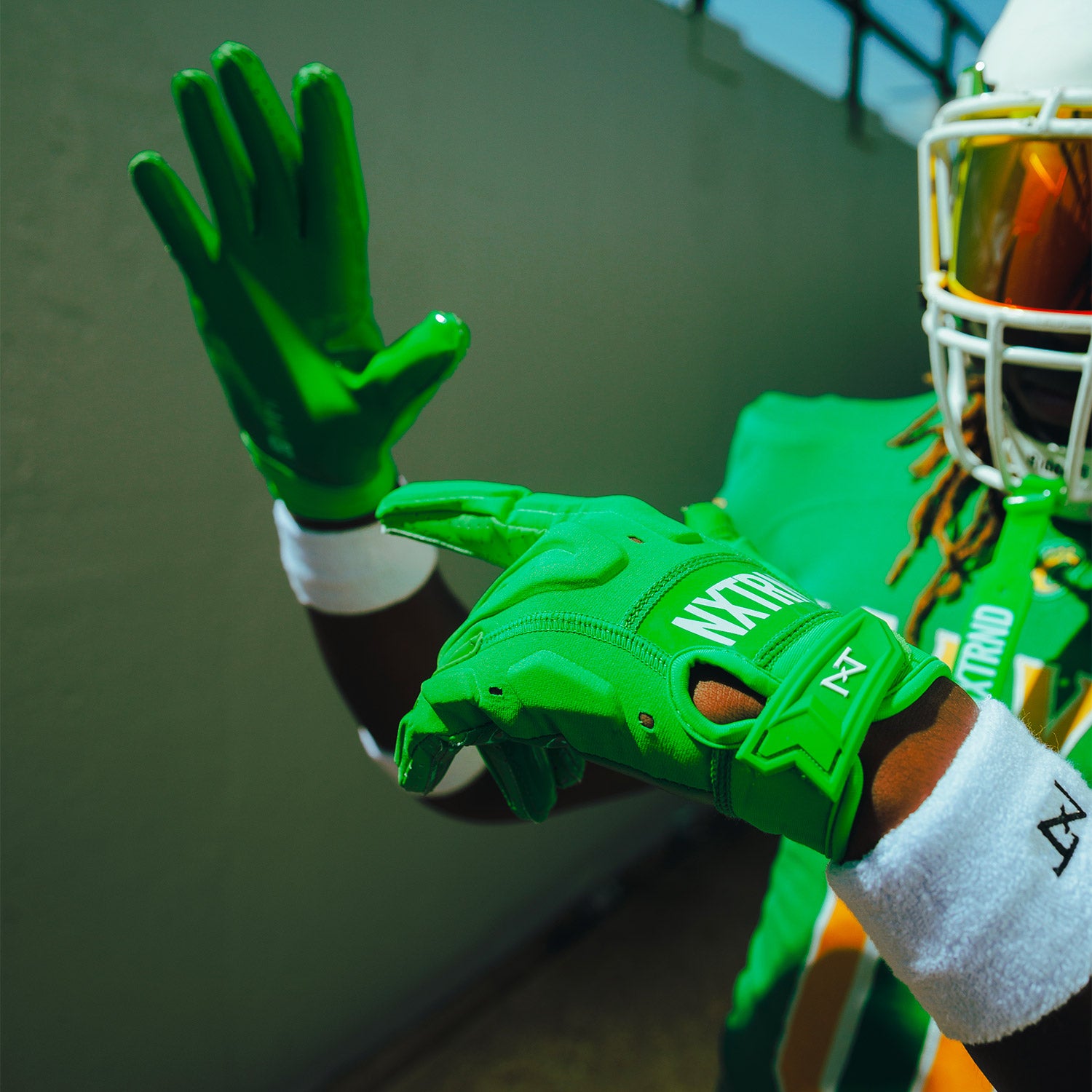 High School Football Player Wearing NXTRND G3 Pro Padded Football Gloves Green Close Up