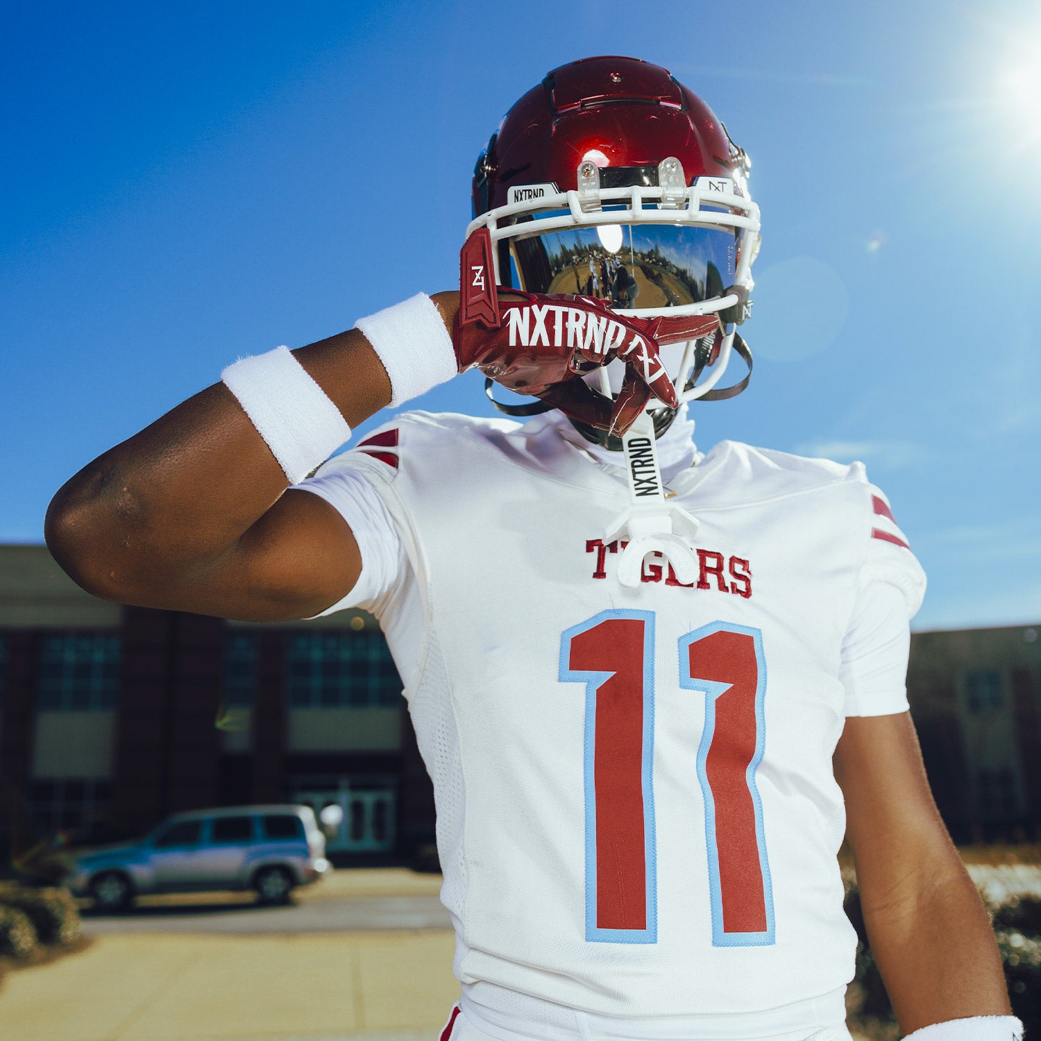 High School Football Player Outside Wearing NXTRND G1 Pro Football Gloves Maroon and TWO Football Mouthguard White