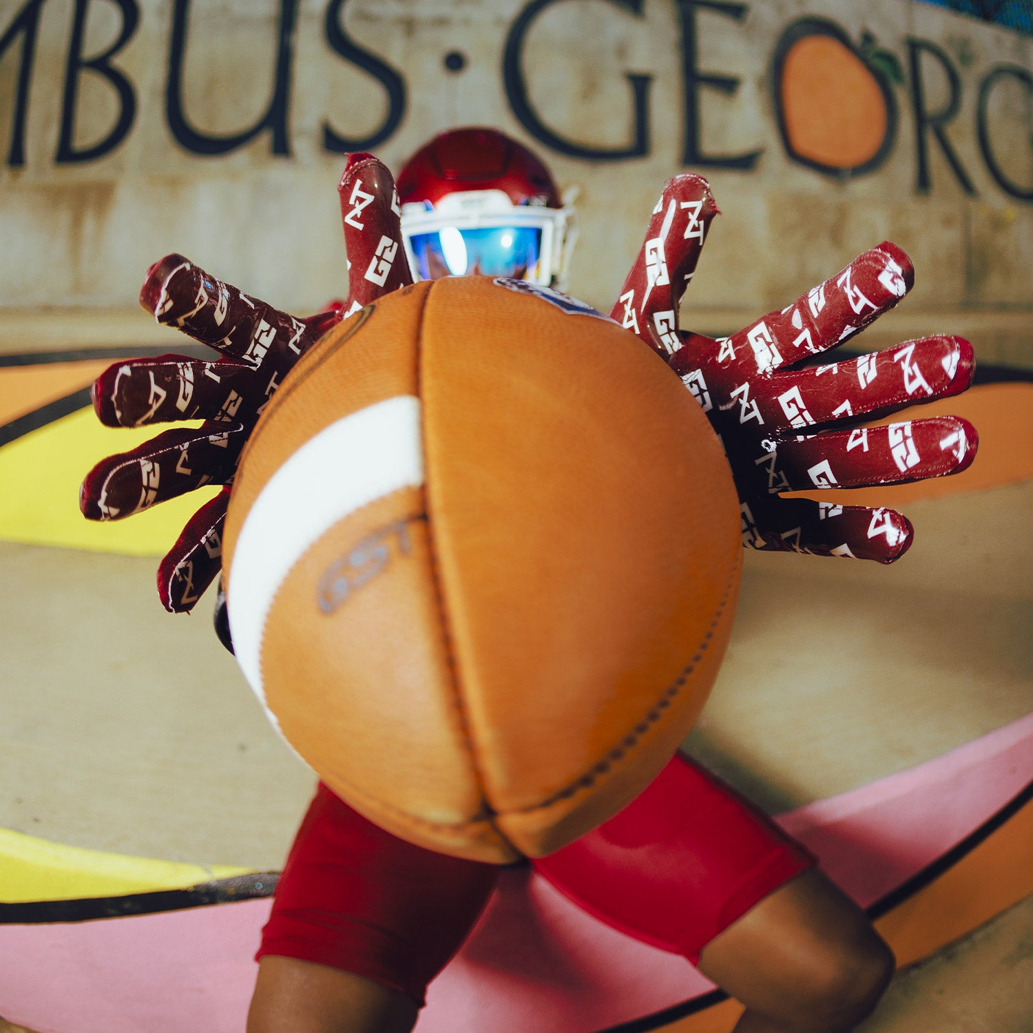 High School Football Player Wearing NXTRND G2 Pro Football Gloves Maroon Close Up