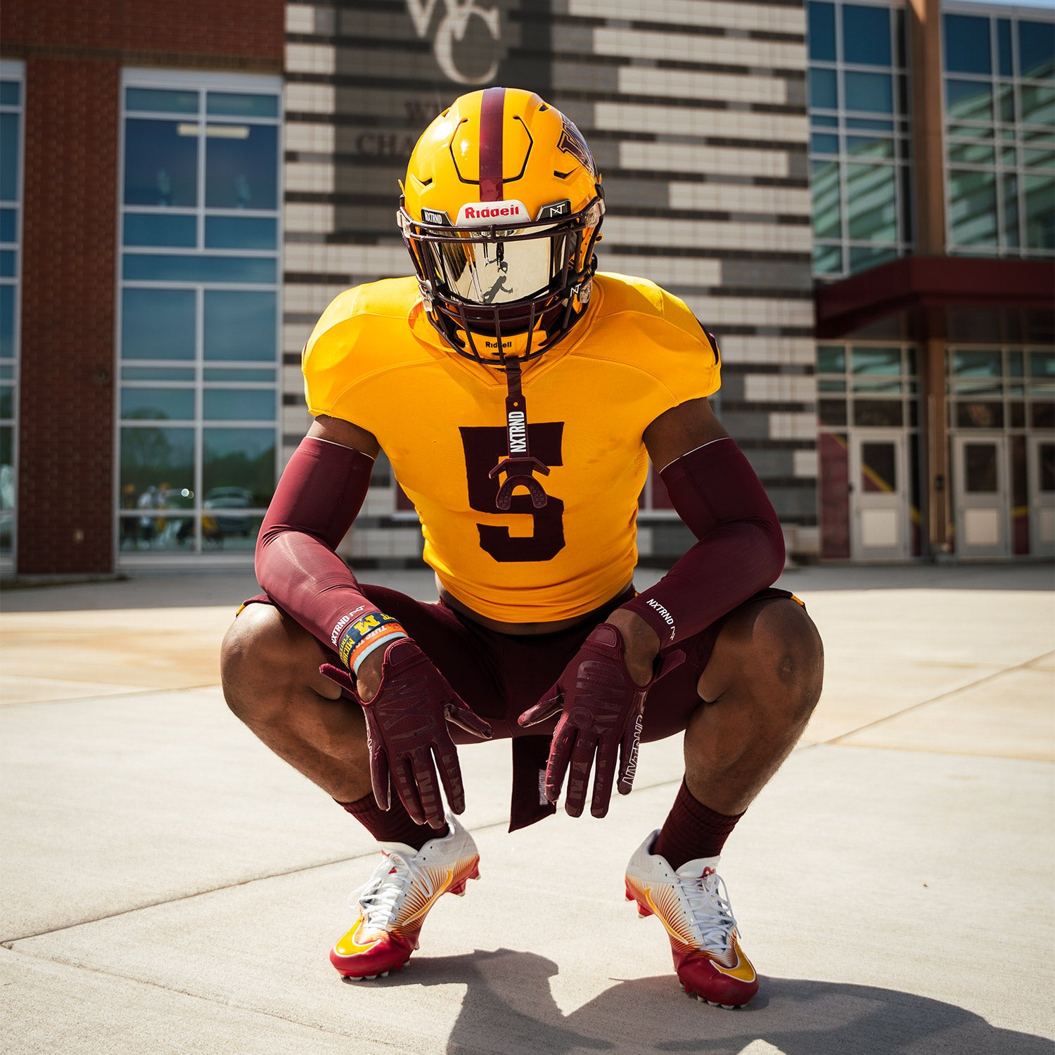High School Football Player Wearing NXTRND Crew Mid Cut Padded Socks Maroon and G1 Pro Football Gloves Maroon