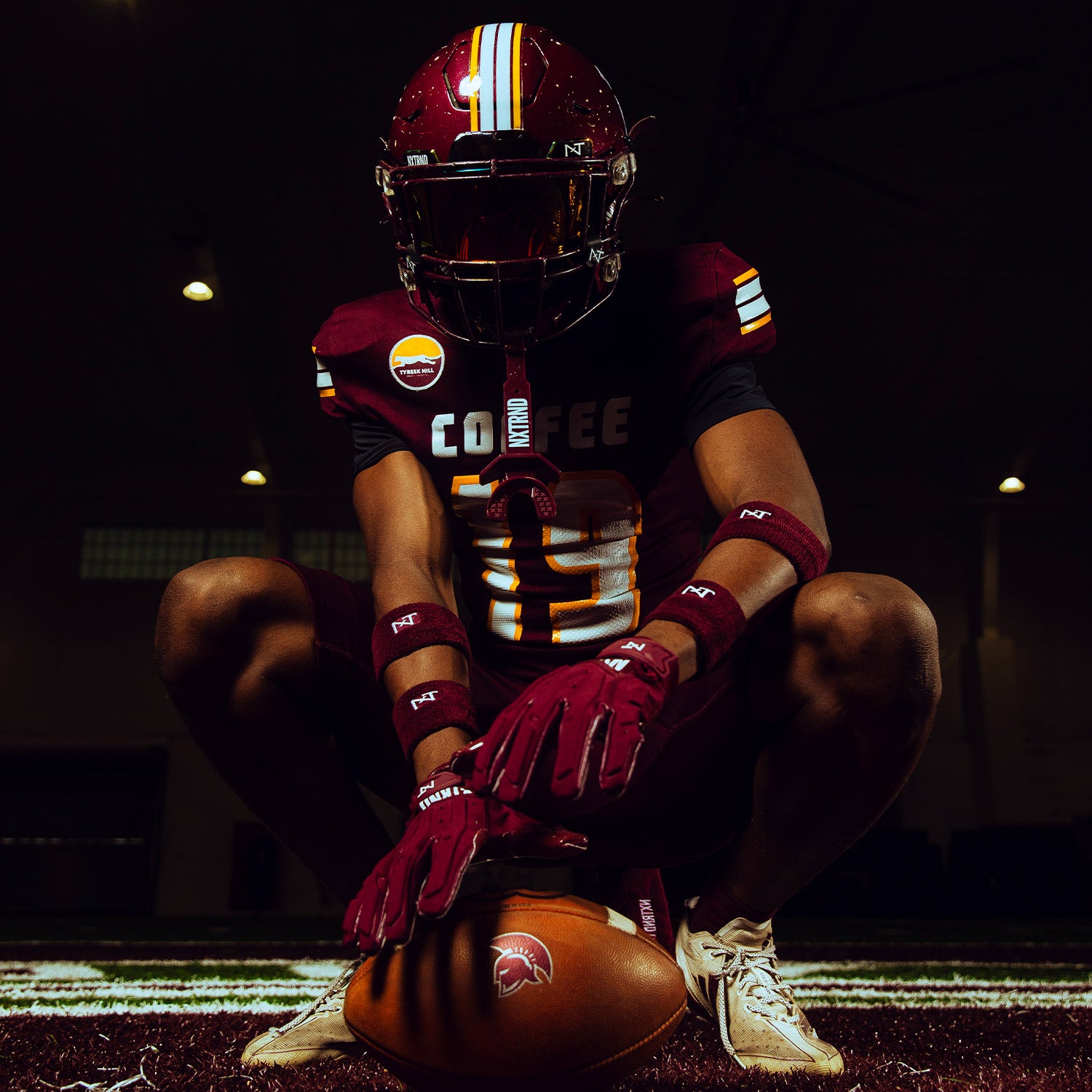 High School Football Player Wearing NXTRND Wrist Band Maroon and G3 Pro Padded Football Gloves Maroon