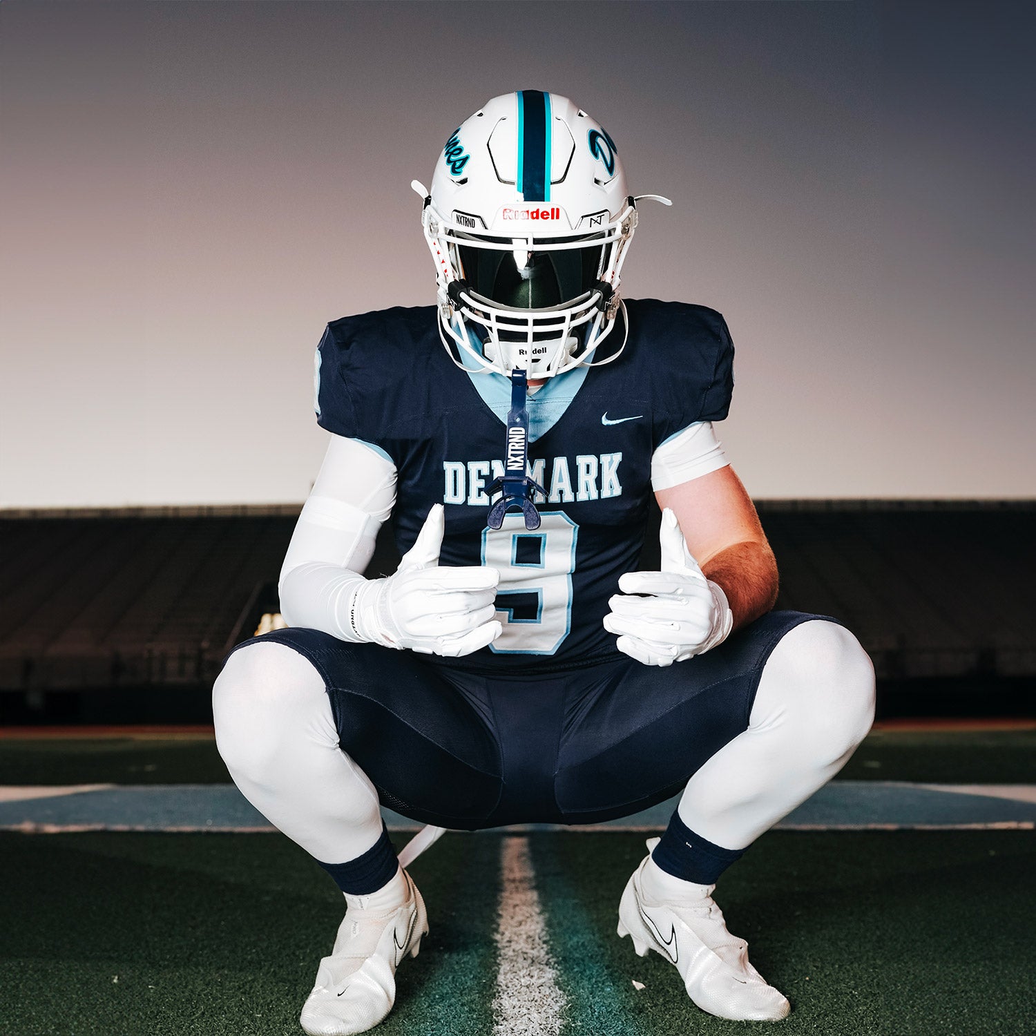 High School Football Player Wearing NXTRND Crew Mid Cut Padded Socks Navy Blue and G3 Pro Football Gloves White