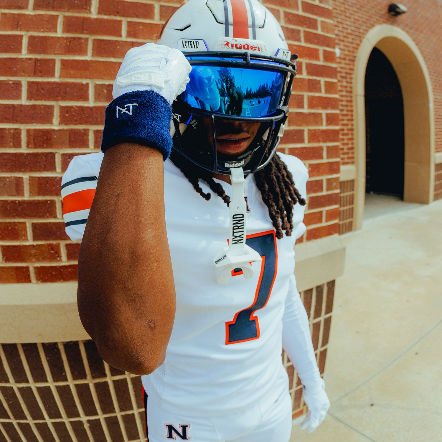 High School Football Player Wearing NXTRND Wrist Band Navy Blue and VZR3 Football Visor Blue