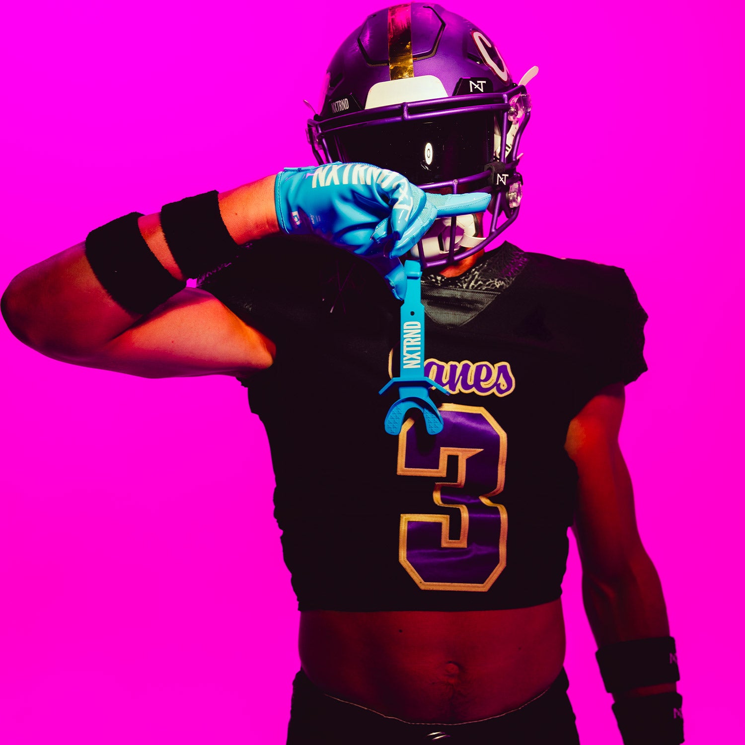 Highschool Football Player Wearing NXTRND TWO Strap Football Lip Mouthguard and G1 Gloves in Neon Blue