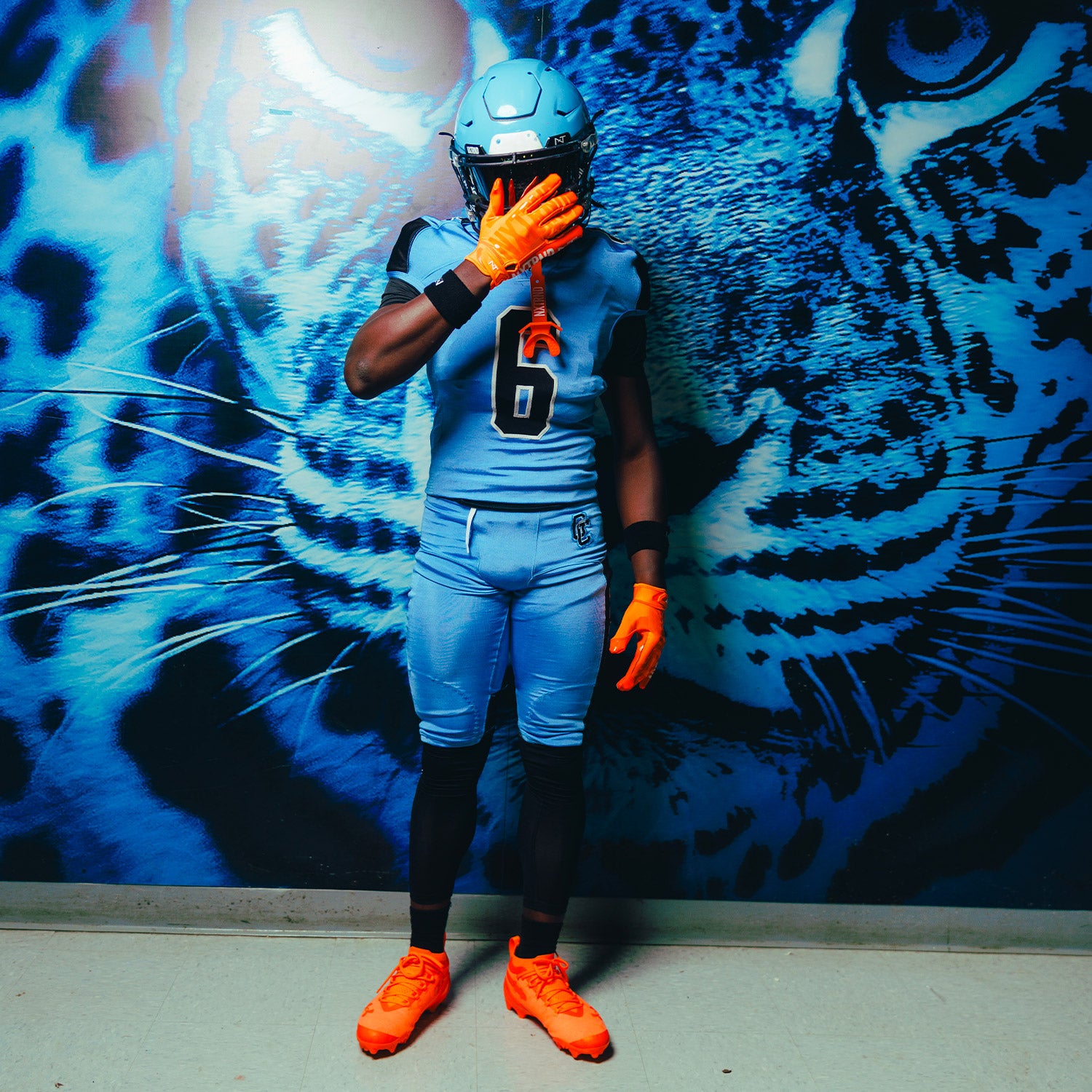 High School Football Player Wearing NXTRND G1 Pro Football Gloves Orange and TWO Football Mouthguard Orange