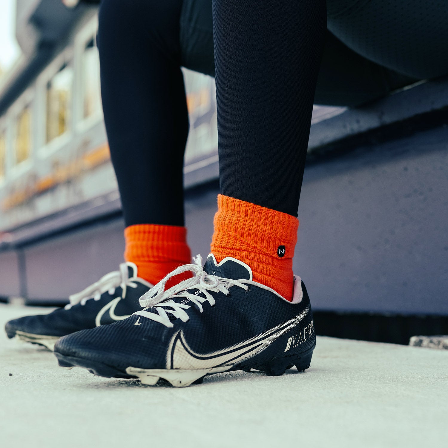High School Football Player Wearing NXTRND Crew Mid Cut Padded Socks Orange