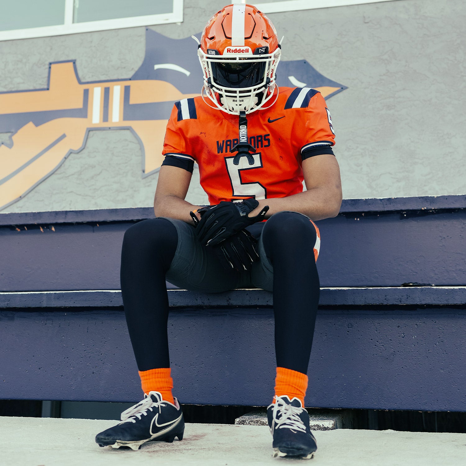 High School Football Player Wearing NXTRND Crew Mid Cut Padded Socks Orange and G3 Pro Football Gloves