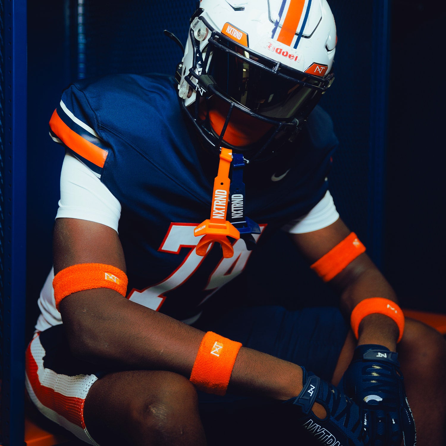High School Football Player Wearing NXTRND Wrist Band Orange and Double TWO Football Mouthguard