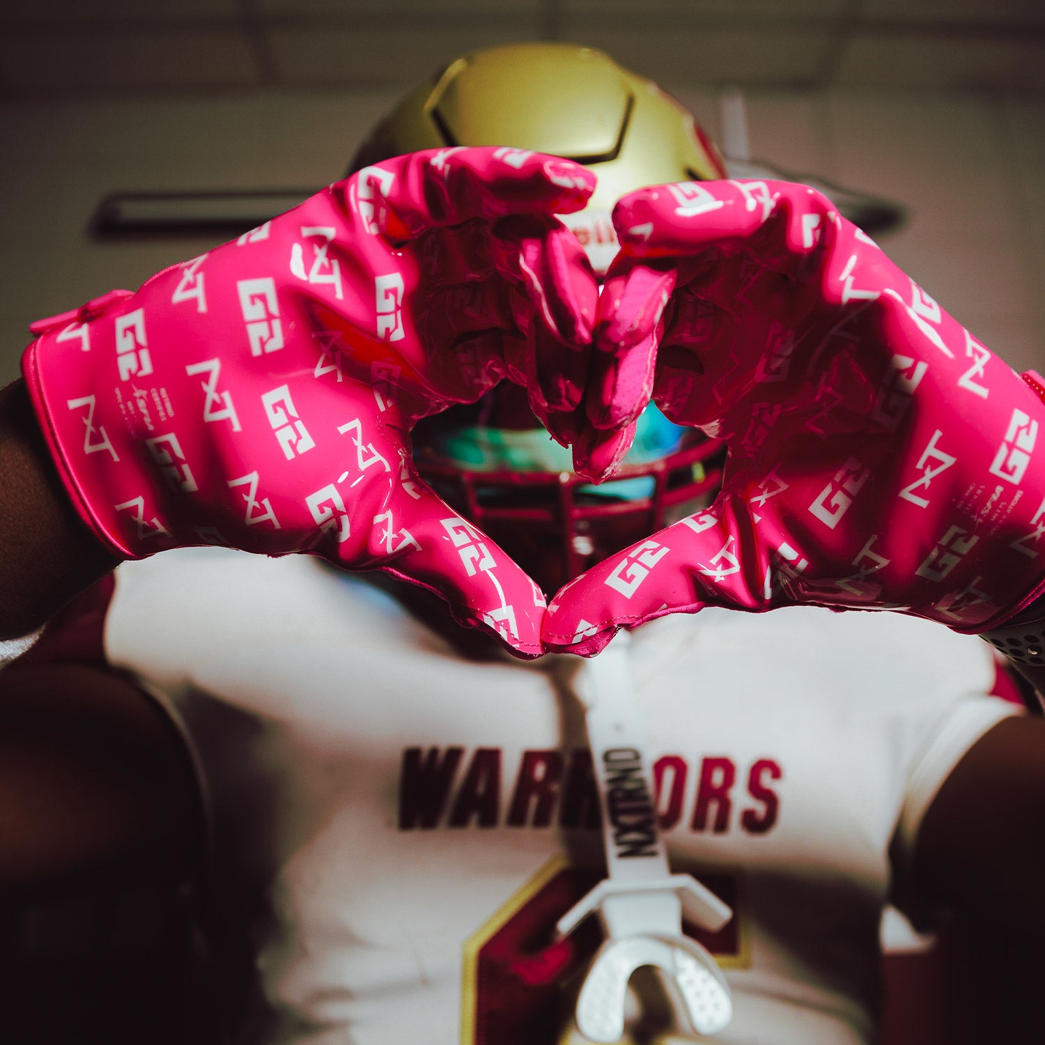 High School Football Player Wearing NXTRND G2 Pro Football Gloves Pink Close Up