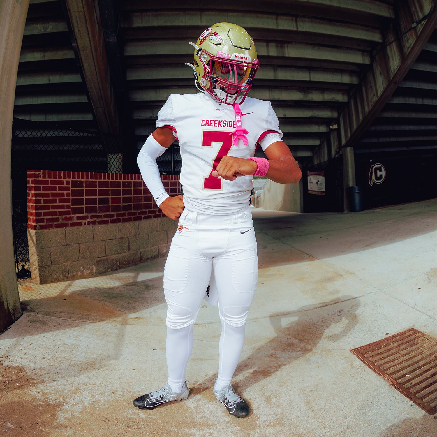 High School Football Player Wearing NXTRND Wrist Band Pink and VZR3 Football Visor Clear