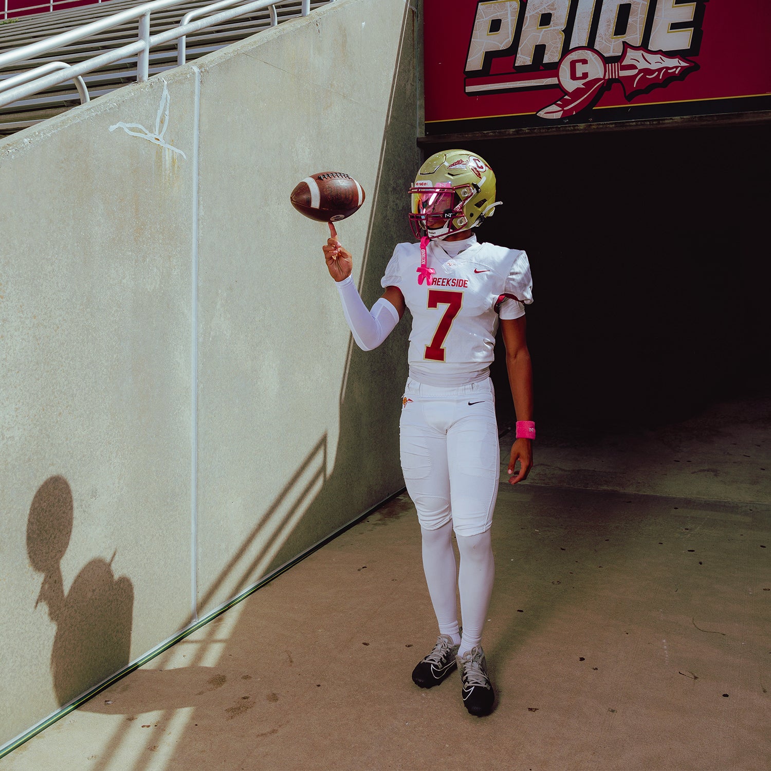 High School Football Player Wearing NXTRND Wrist Band Pink and TWO Football Mouthguard Pink