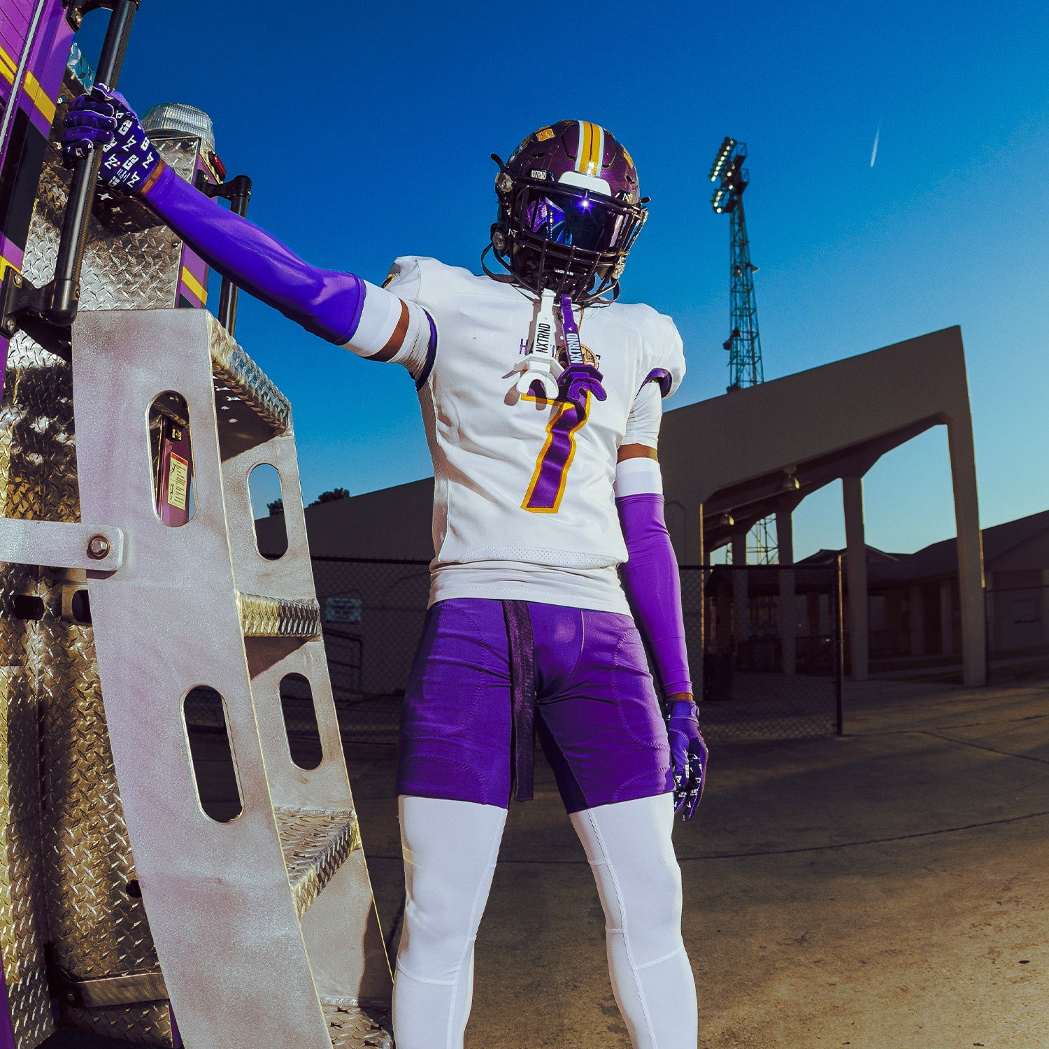 High School Football Player Wearing NXTRND Double Layer Compression Arm Sleeve Purple and VZR3 Football Visor Purple
