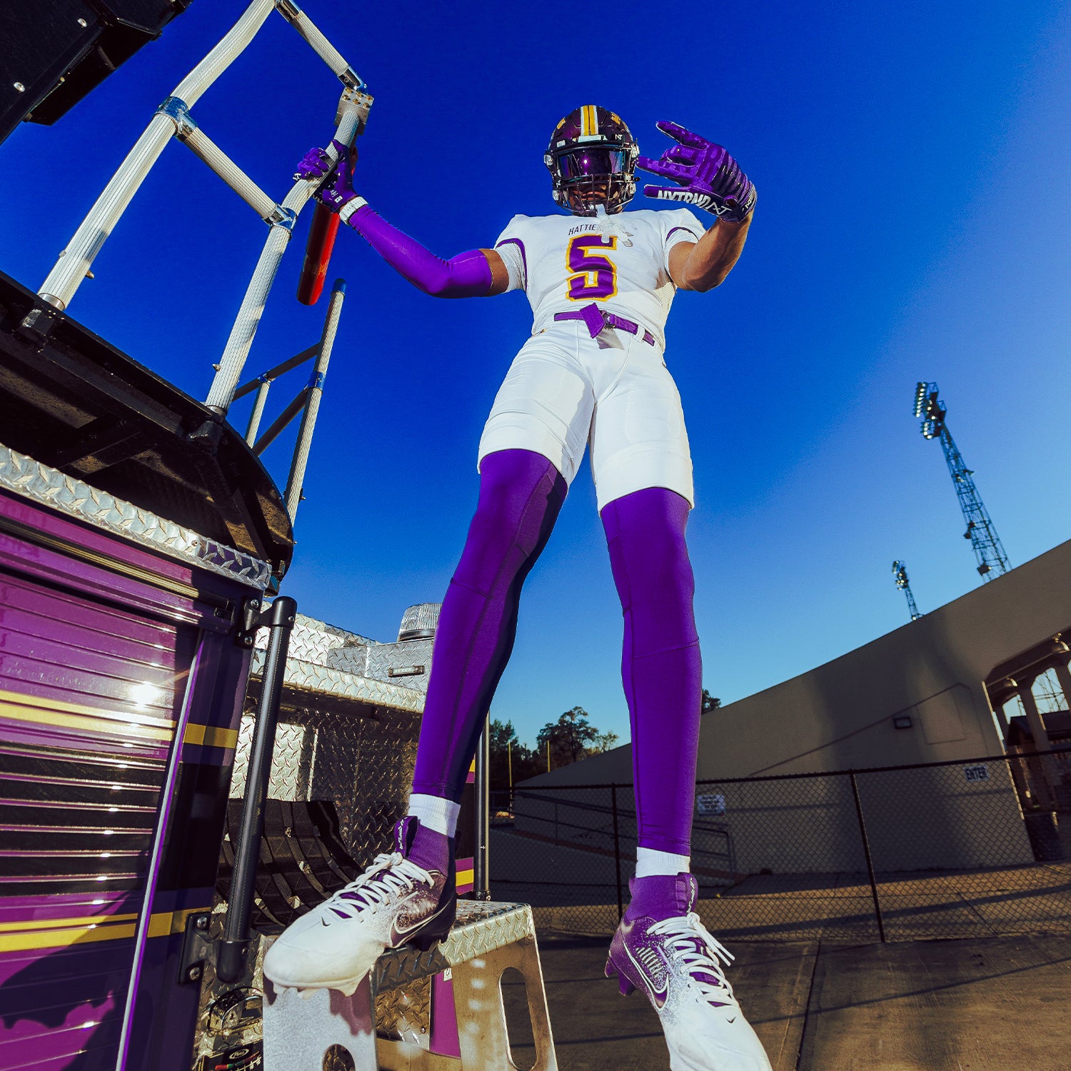 High School Football Player Wearing NXTRND G1 Pro Football Gloves Purple and Core Compression Pants Purple