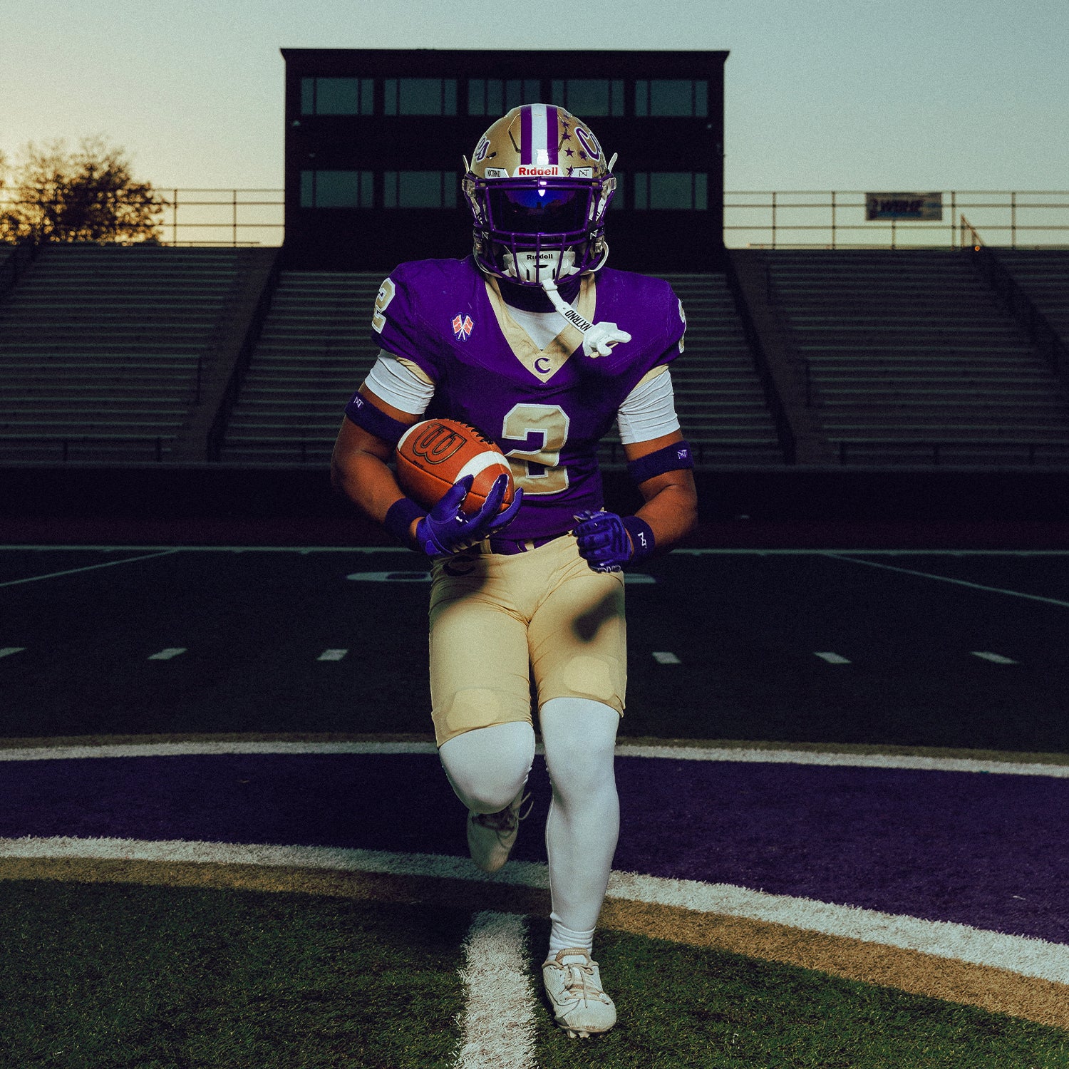 High School Football Player Wearing NXTRND Wrist Band Purple and VZR3 Football Visor Purple