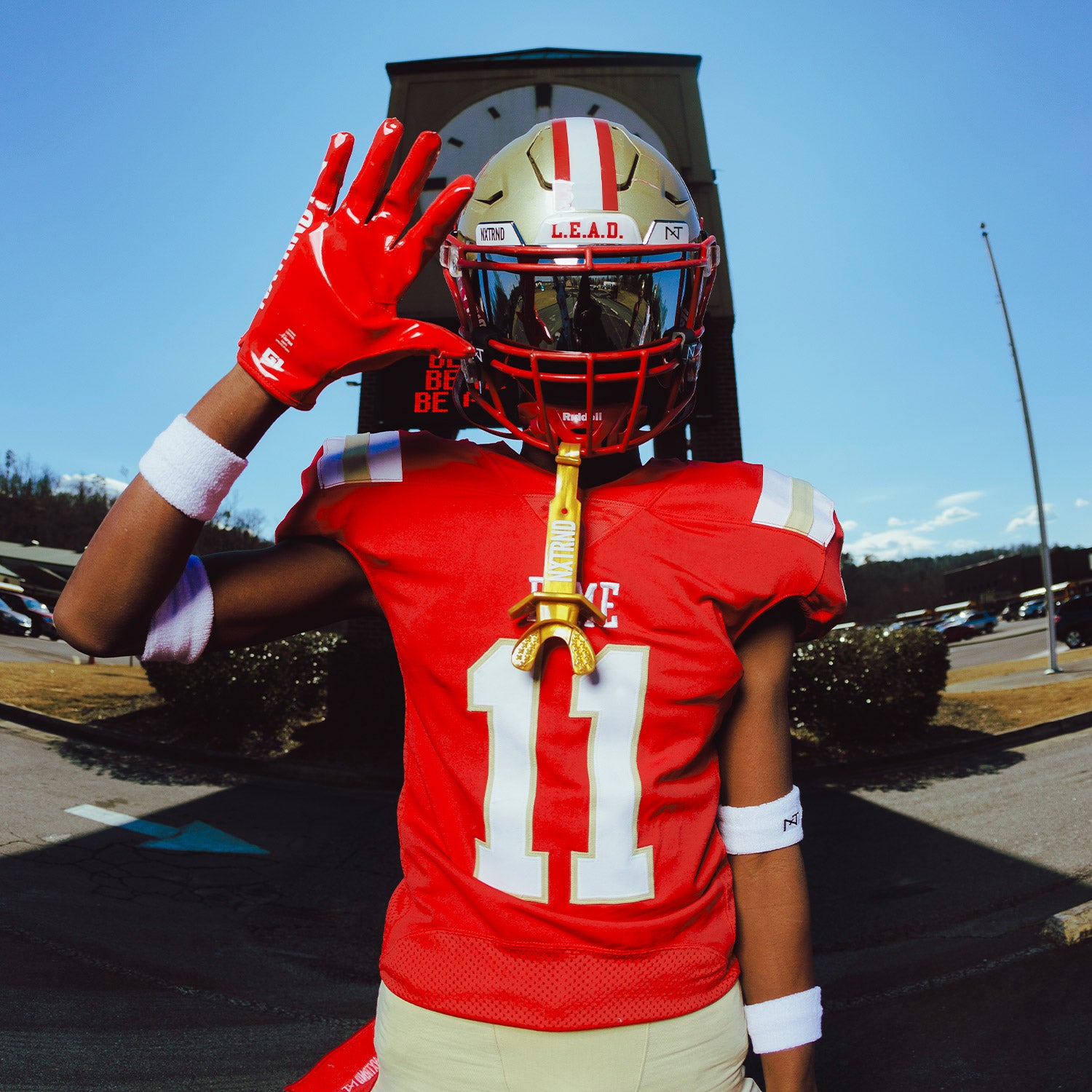 High School Football Player Wearing NXTRND G1 Pro Football Gloves Red and TWO Mouthguard in Gold