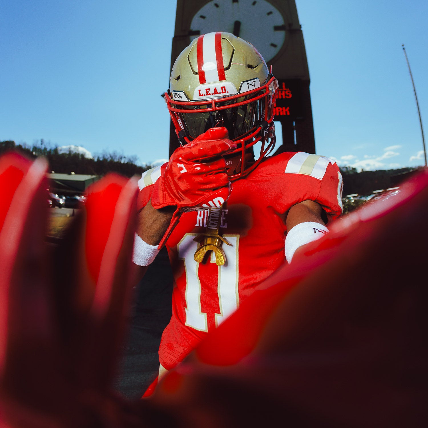 High School Football Player Wearing NXTRND G1 Pro Football Gloves Red Close Up