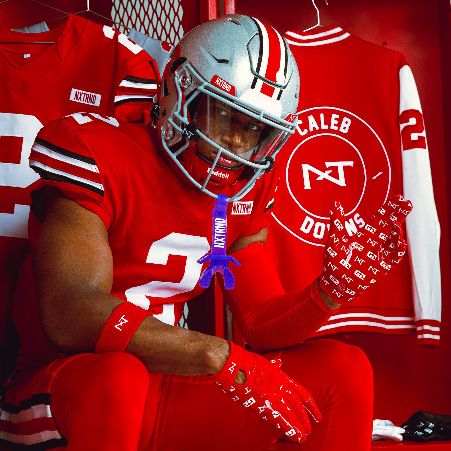 NCAA Star Football Player Caleb Downs Wearing NXTRND G2 Pro Football Gloves Red and TWO Mouthguard Purple