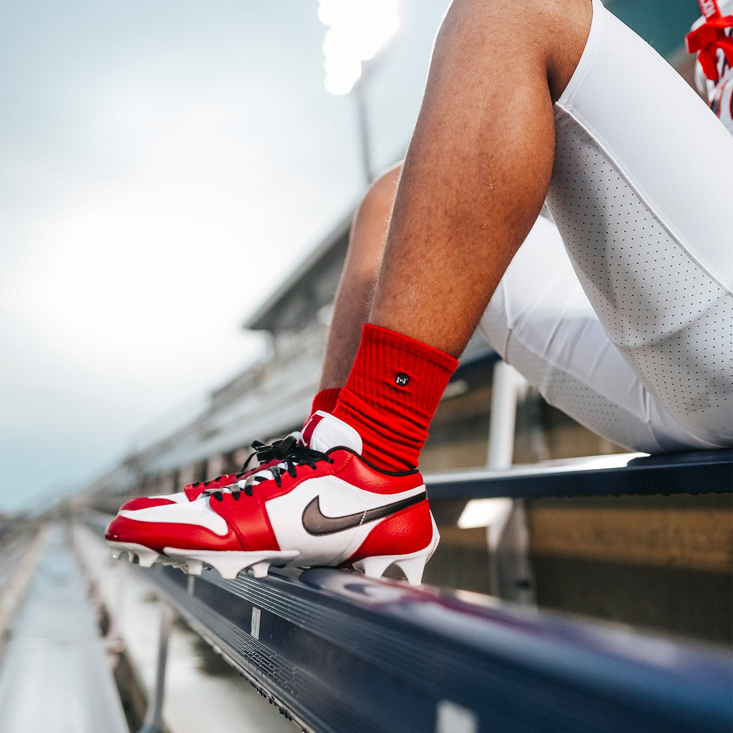 High School Football Player Wearing NXTRND Crew Mid Cut Padded Socks Red