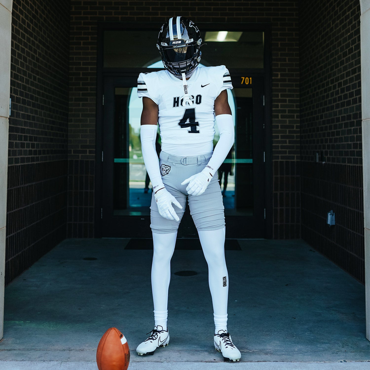 High School Football Player Wearing Nxtrnd Core Tights Compression Legging Pants White and Arm Sleeves White