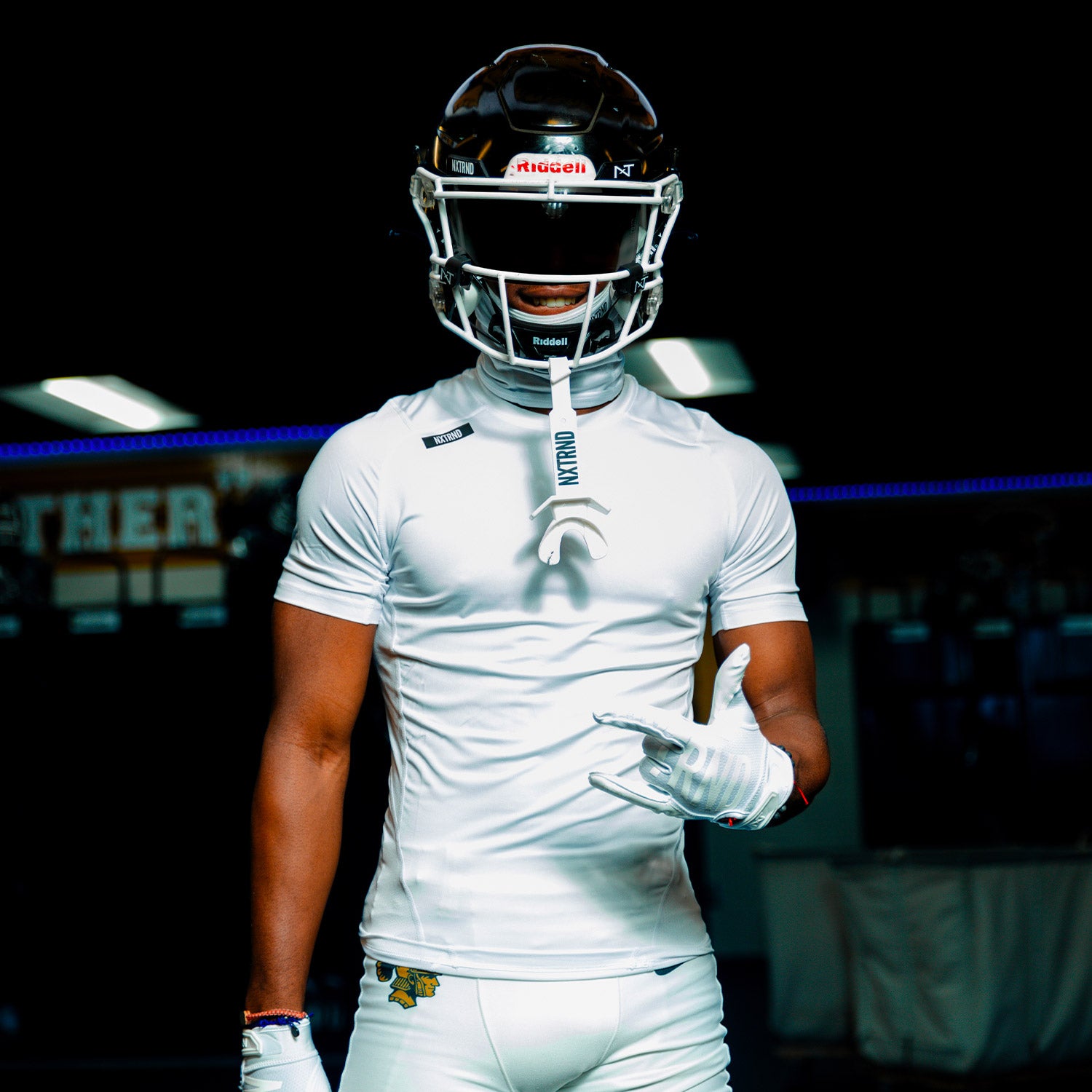 High School ootball Player Wearing Nxtrnd Core Compression Short Sleeve Shirt White and TWO Football Mouthguard White