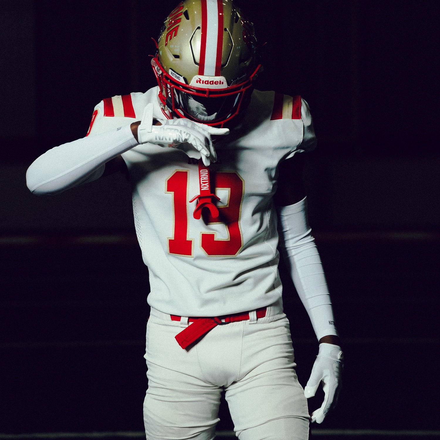 High School Football Player Wearing NXTRND G1 Pro Football Gloves White and Two Mouthguard in Red
