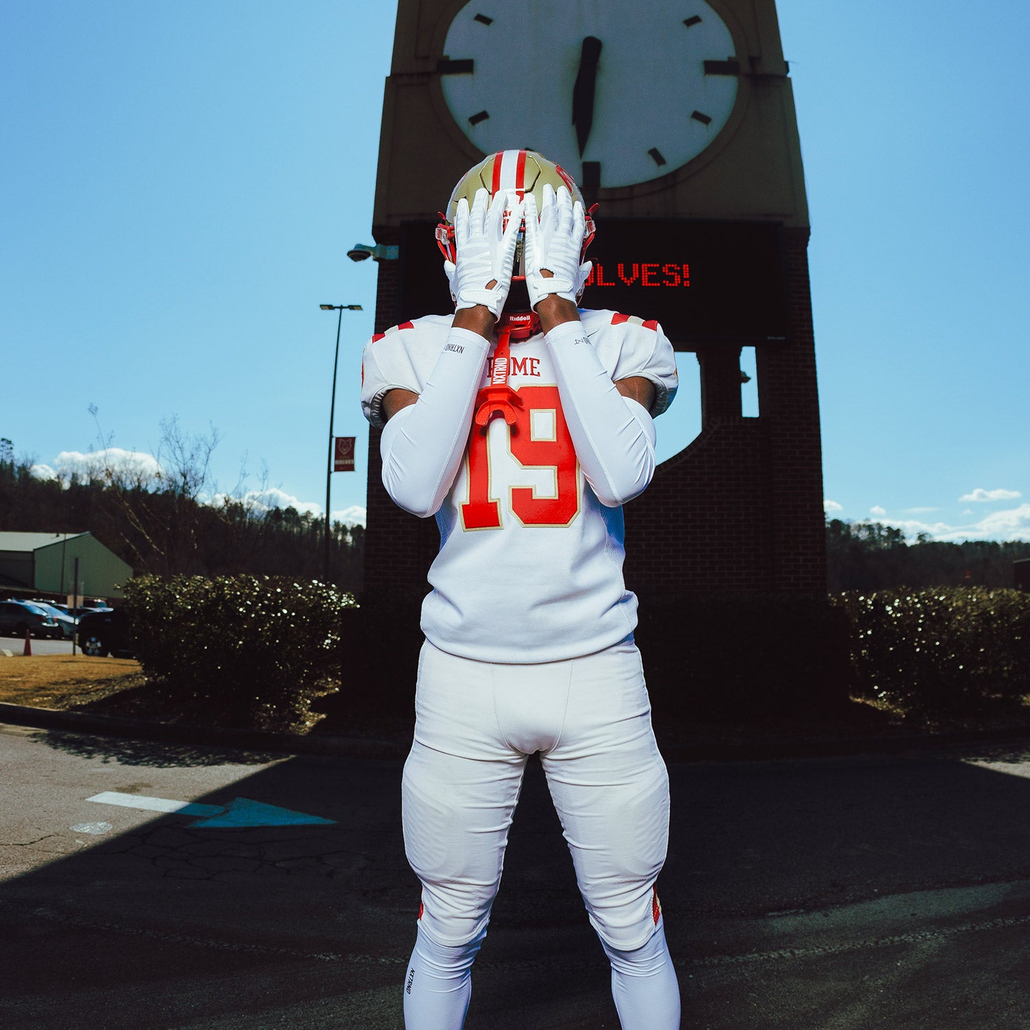 High School Football Player Outside Wearing NXTRND G1 Pro Football Gloves White and TWO Mouthguard in Red