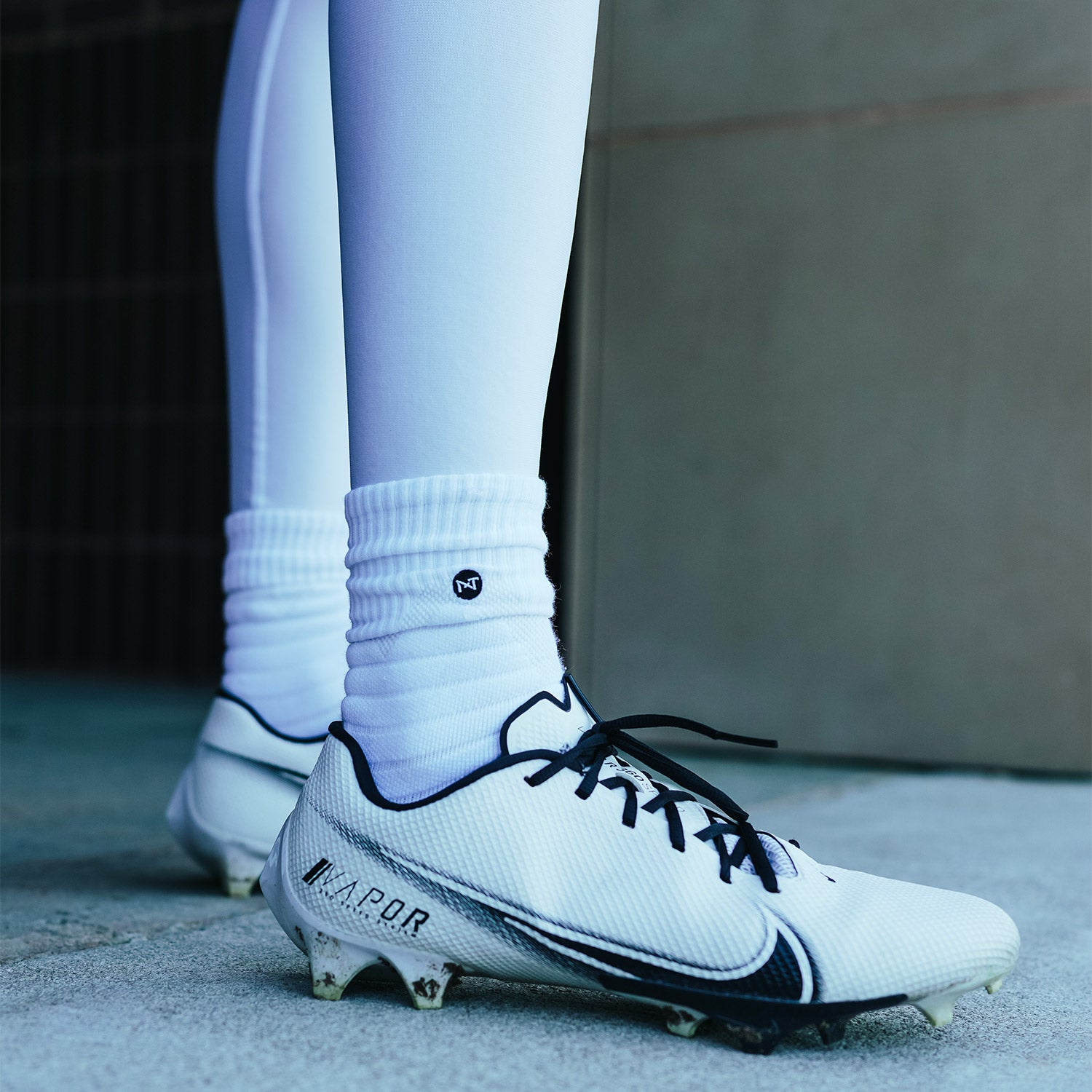 High School Football Player Wearing NXTRND Crew Mid Cut Padded Socks White and Core Compression Pants White