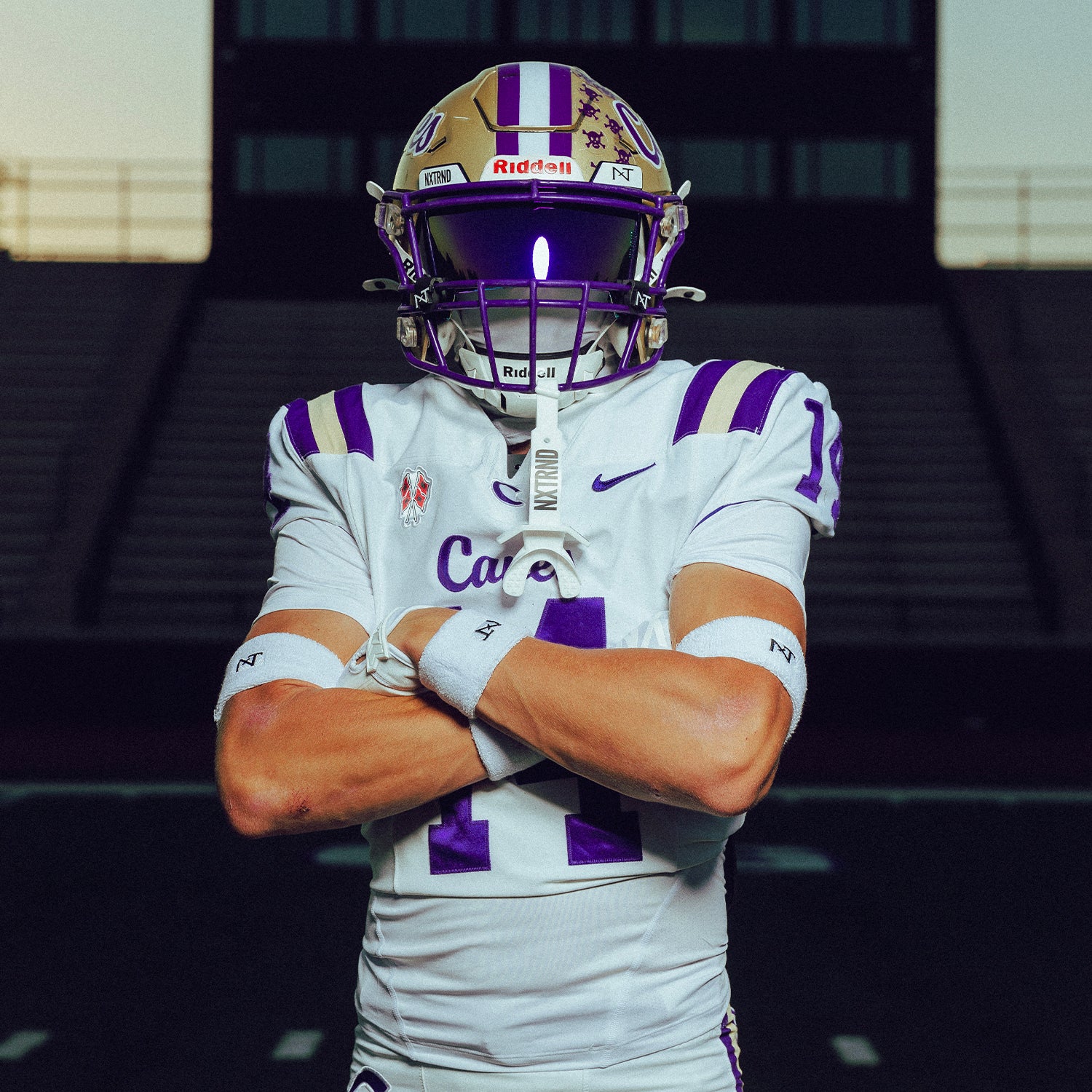 High School Football Player Wearing NXTRND Wrist Band White and VZR3 Football Visor Purple