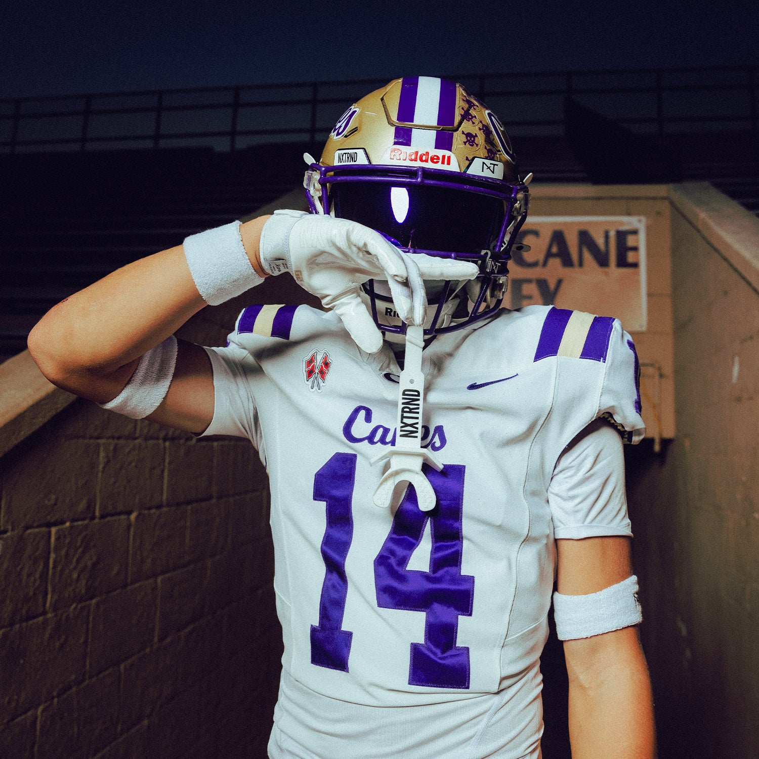 High School Football Player Wearing NXTRND Wrist Band White and TWO Football Mouthguard White