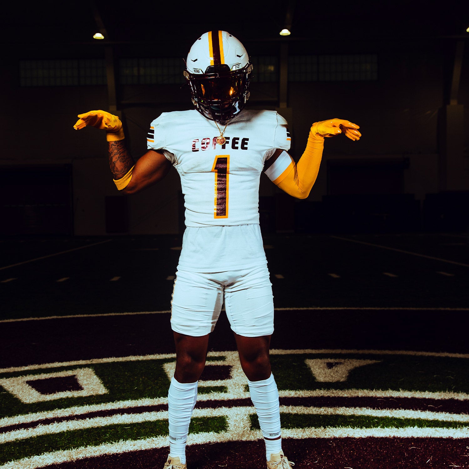 High School Football Player On Field Wearing NXTRND Double Layer Compression Arm Sleeve Yellow and VZR3 Football Visor Gold