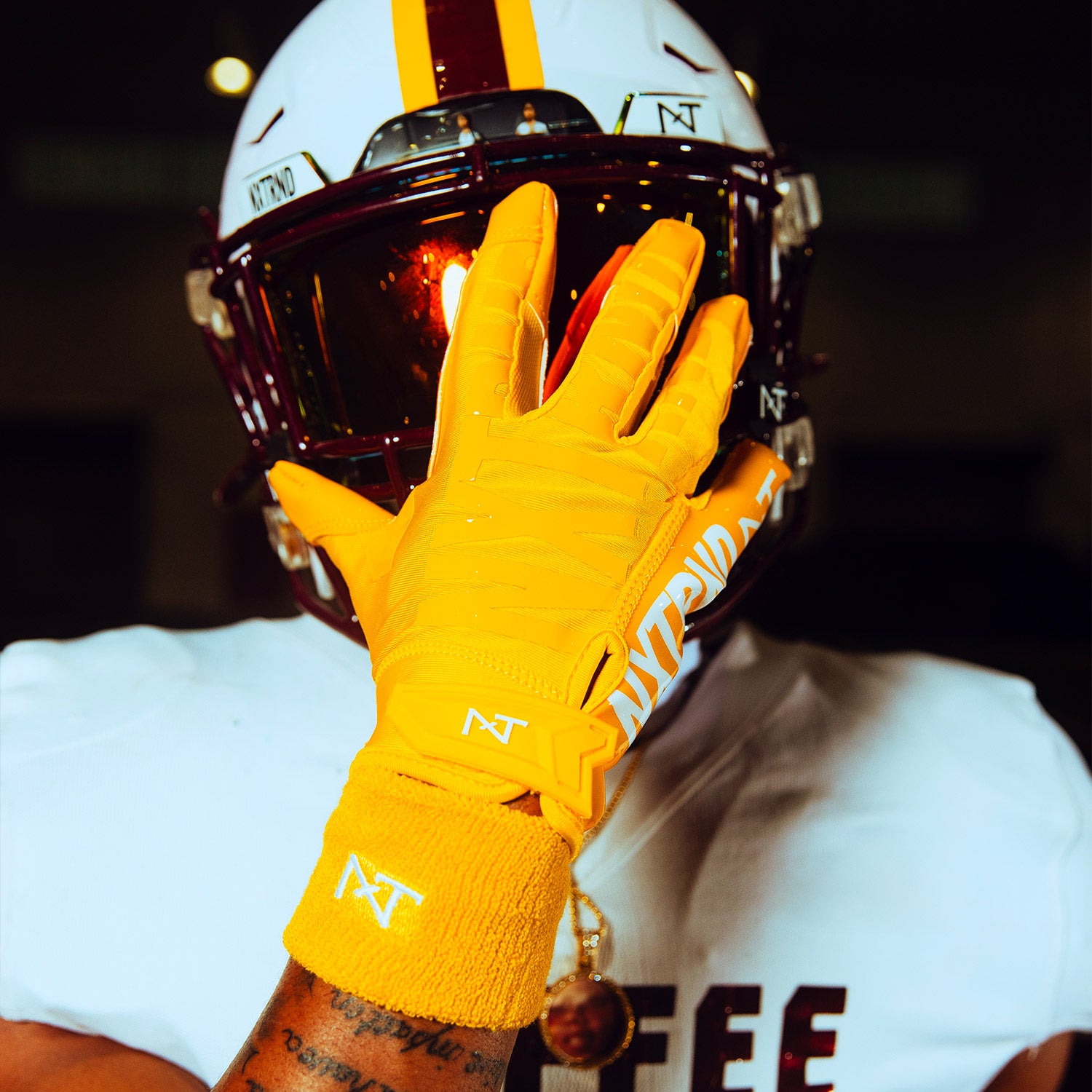 High School Football Player Wearing NXTRND G1 Pro Football Gloves and Wrist Bands in Yellow