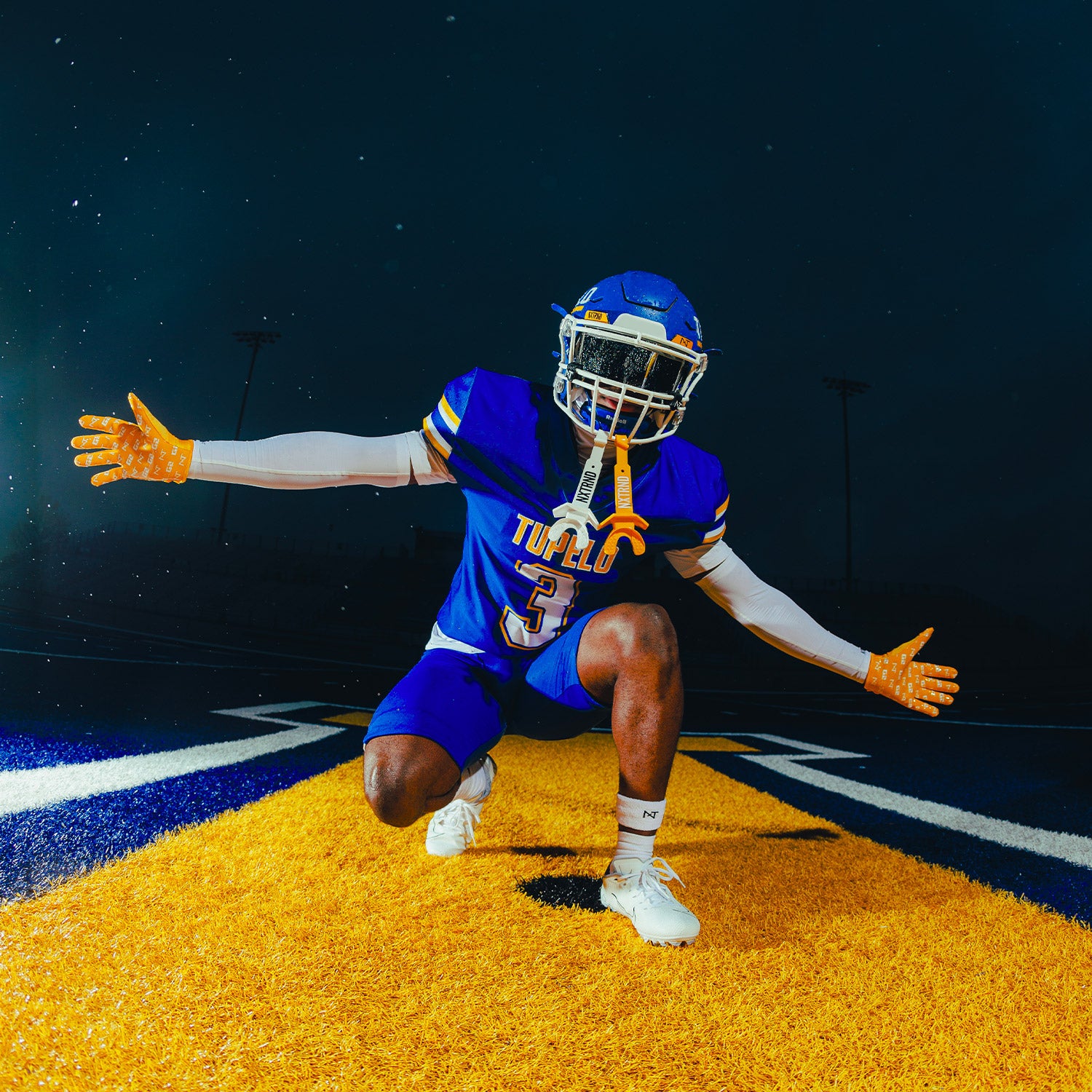 High School Football Player On Field Wearing NXTRND G2 Pro Football Gloves Yellow and Double TWO Football Mouthguard