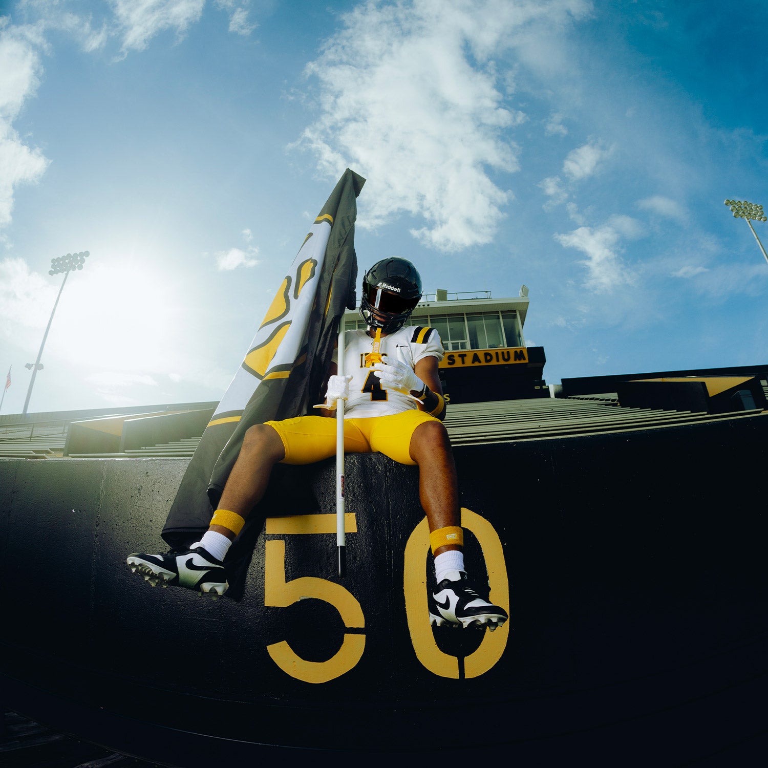 High School Football Player Wearing NXTRND Wrist Band Yellow and G1 Pro Football Gloves White