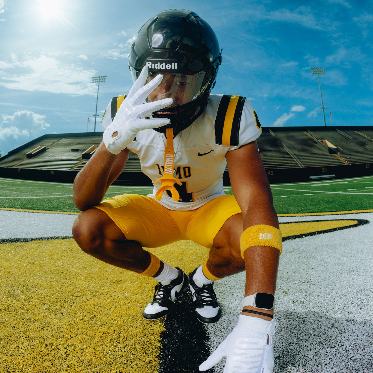 High School Football Player Wearing NXTRND Wrist Band Yellow and TWO Football Mouthguard Yellow