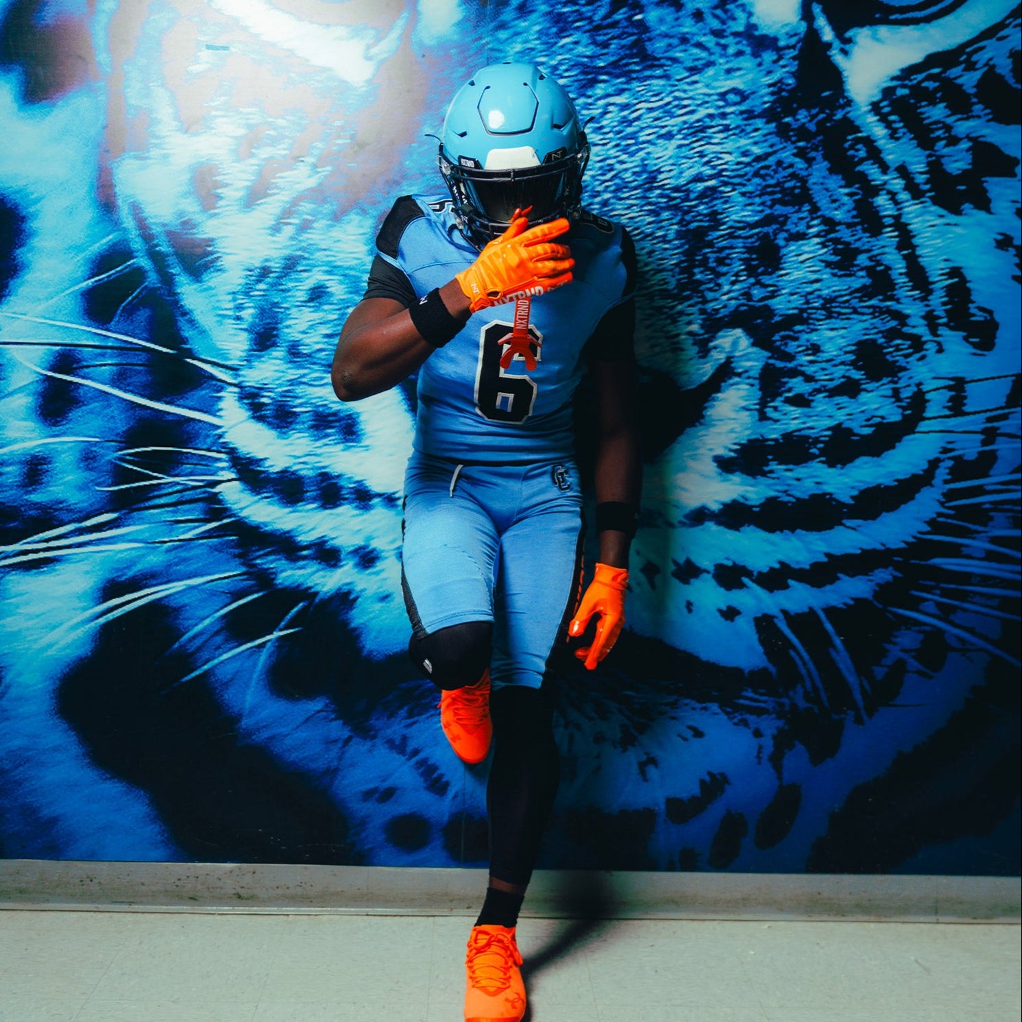 High School Football Athlete Wearing NXTRND G1 Pro Football Gloves Orange and TWO Football Mouthguard Orange